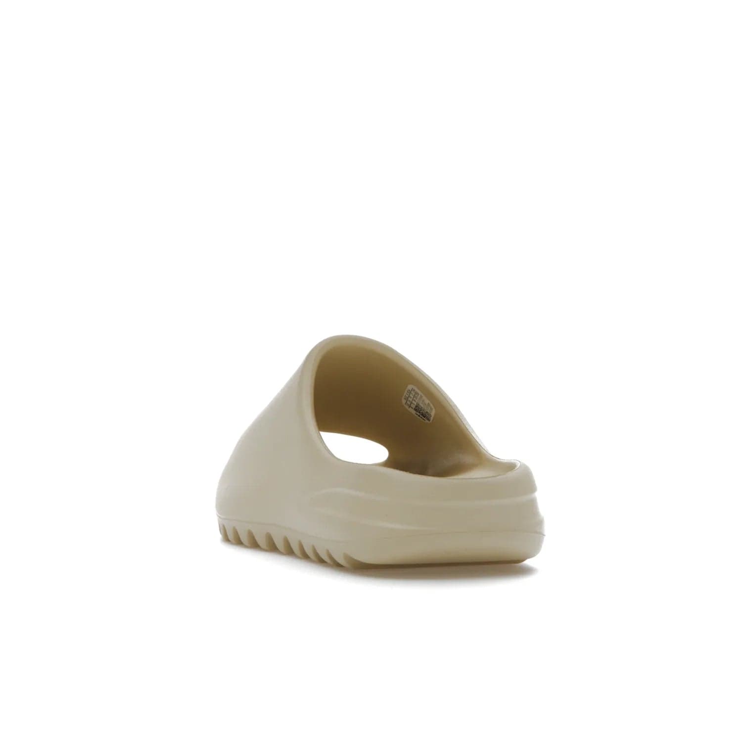 adidas Yeezy Slide Bone (2022 Restock) - Image 26 - Only at www.BallersClubKickz.com - Stay comfy with the adidas Yeezy Slide Bone - a fashionable silhouette with all-day comfort. This Bone/Bone/Bone colorway combines style and comfort with a pebbled texture and grooved sole. Restocked in May 2022, this shoe is the perfect addition to your collection.