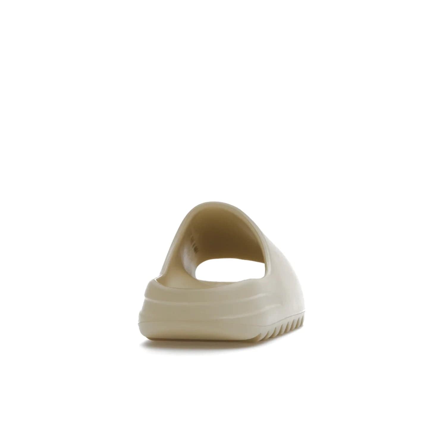 adidas Yeezy Slide Bone (2022 Restock) - Image 29 - Only at www.BallersClubKickz.com - Stay comfy with the adidas Yeezy Slide Bone - a fashionable silhouette with all-day comfort. This Bone/Bone/Bone colorway combines style and comfort with a pebbled texture and grooved sole. Restocked in May 2022, this shoe is the perfect addition to your collection.