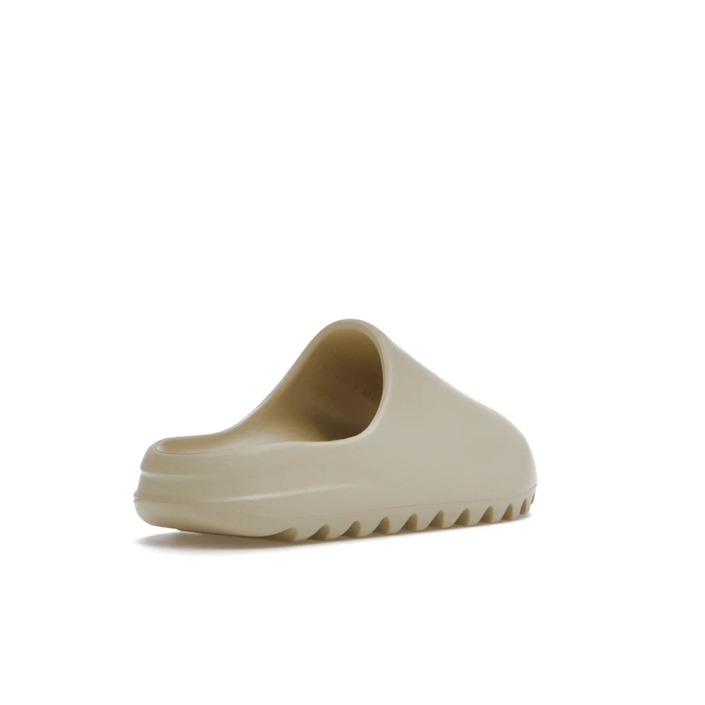 adidas Yeezy Slide Bone (2022 Restock) - Image 32 - Only at www.BallersClubKickz.com - Stay comfy with the adidas Yeezy Slide Bone - a fashionable silhouette with all-day comfort. This Bone/Bone/Bone colorway combines style and comfort with a pebbled texture and grooved sole. Restocked in May 2022, this shoe is the perfect addition to your collection.