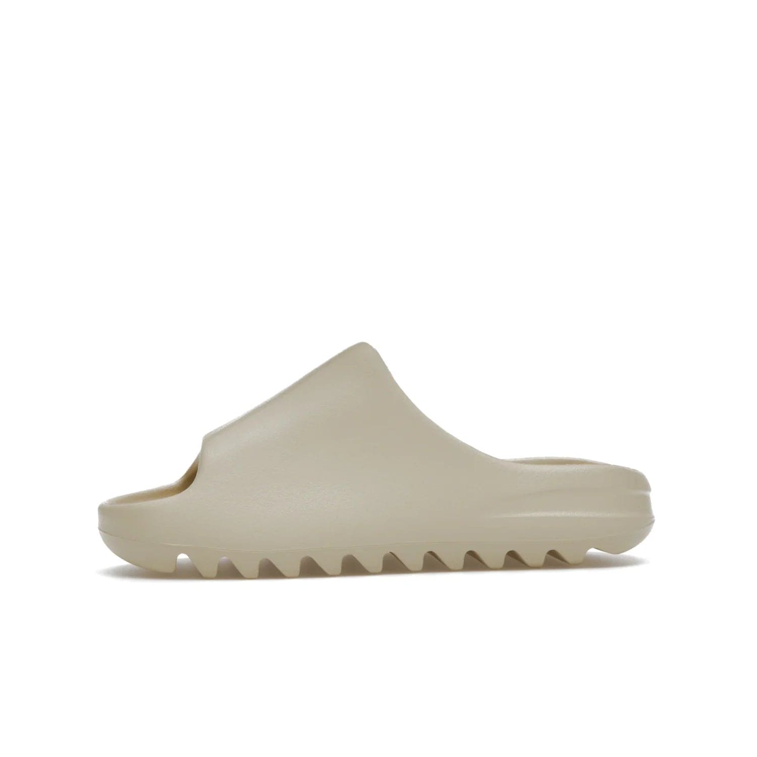 adidas Yeezy Slide Bone (2022 Restock) - Image 18 - Only at www.BallersClubKickz.com - Stay comfy with the adidas Yeezy Slide Bone - a fashionable silhouette with all-day comfort. This Bone/Bone/Bone colorway combines style and comfort with a pebbled texture and grooved sole. Restocked in May 2022, this shoe is the perfect addition to your collection.