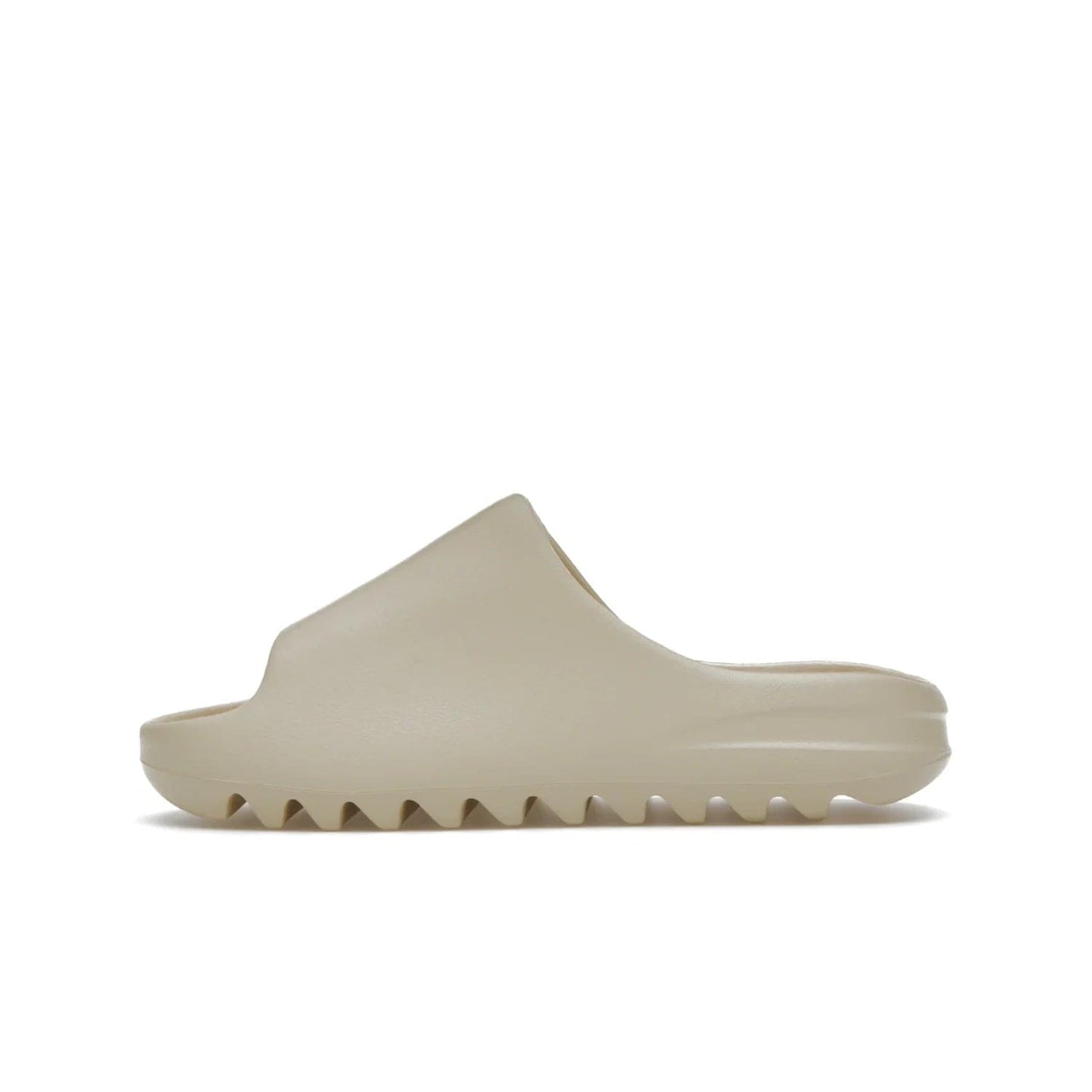 adidas Yeezy Slide Bone (2022 Restock) - Image 19 - Only at www.BallersClubKickz.com - Stay comfy with the adidas Yeezy Slide Bone - a fashionable silhouette with all-day comfort. This Bone/Bone/Bone colorway combines style and comfort with a pebbled texture and grooved sole. Restocked in May 2022, this shoe is the perfect addition to your collection.