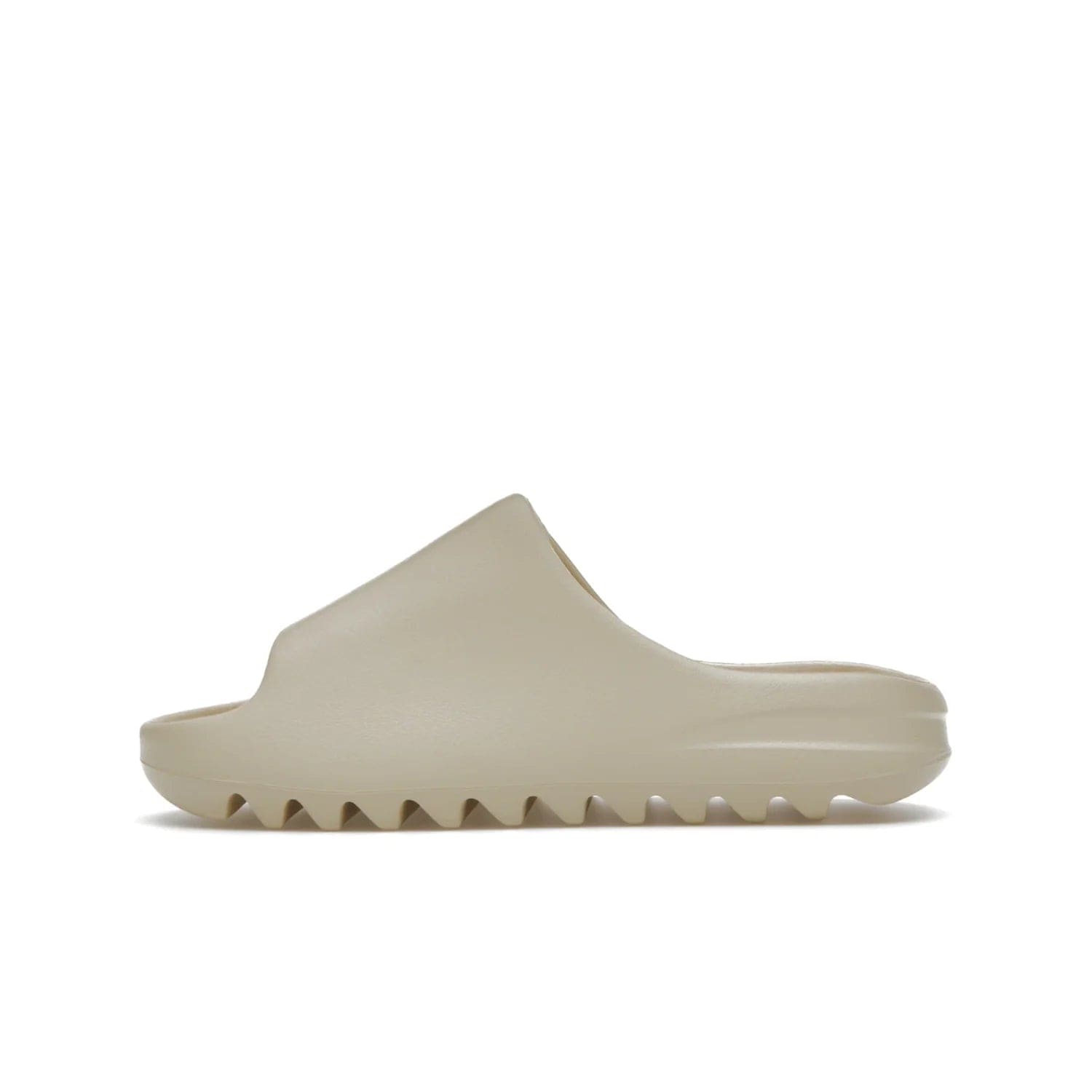 adidas Yeezy Slide Bone (2022 Restock) - Image 19 - Only at www.BallersClubKickz.com - Stay comfy with the adidas Yeezy Slide Bone - a fashionable silhouette with all-day comfort. This Bone/Bone/Bone colorway combines style and comfort with a pebbled texture and grooved sole. Restocked in May 2022, this shoe is the perfect addition to your collection.