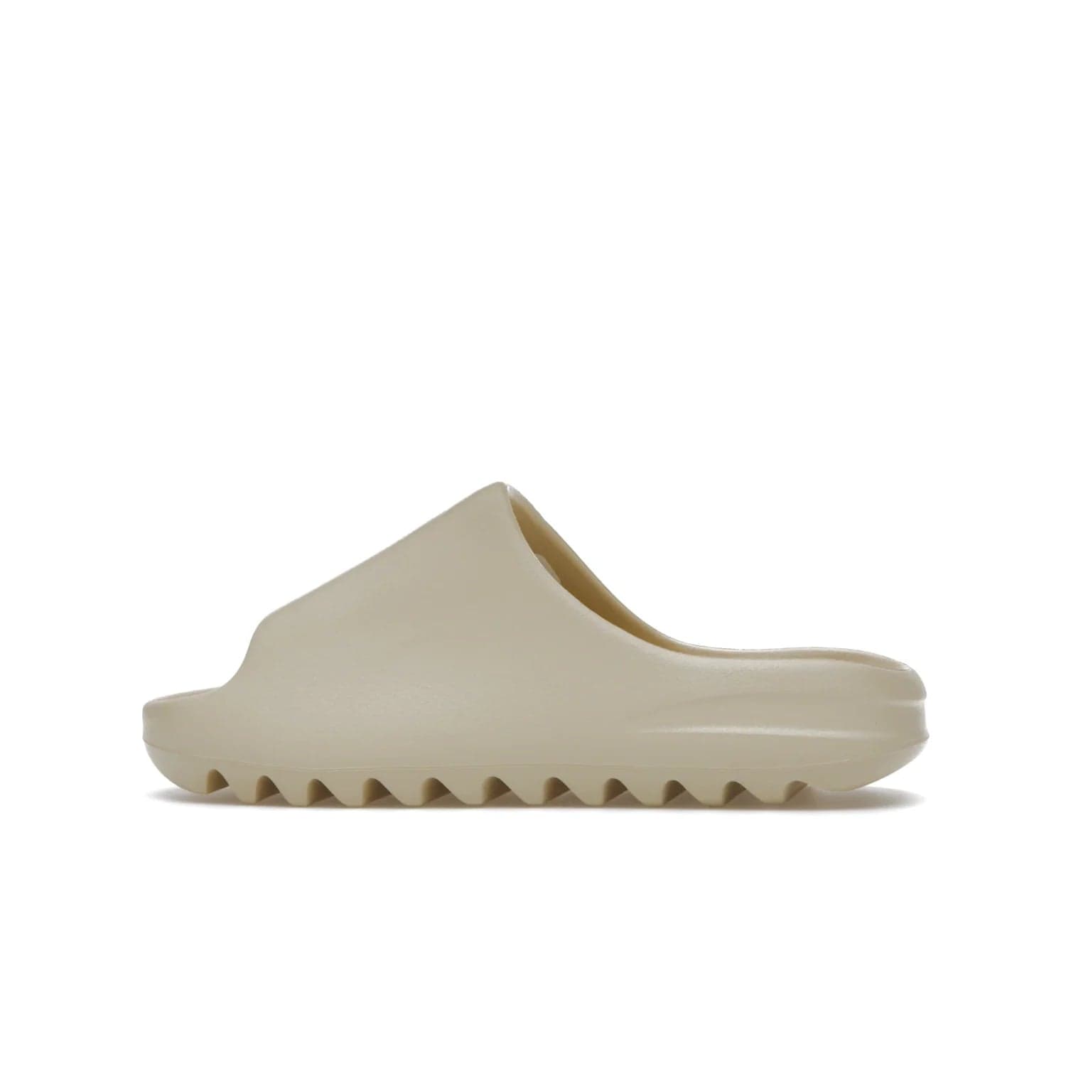 adidas Yeezy Slide Bone (2022 Restock) - Image 20 - Only at www.BallersClubKickz.com - Stay comfy with the adidas Yeezy Slide Bone - a fashionable silhouette with all-day comfort. This Bone/Bone/Bone colorway combines style and comfort with a pebbled texture and grooved sole. Restocked in May 2022, this shoe is the perfect addition to your collection.