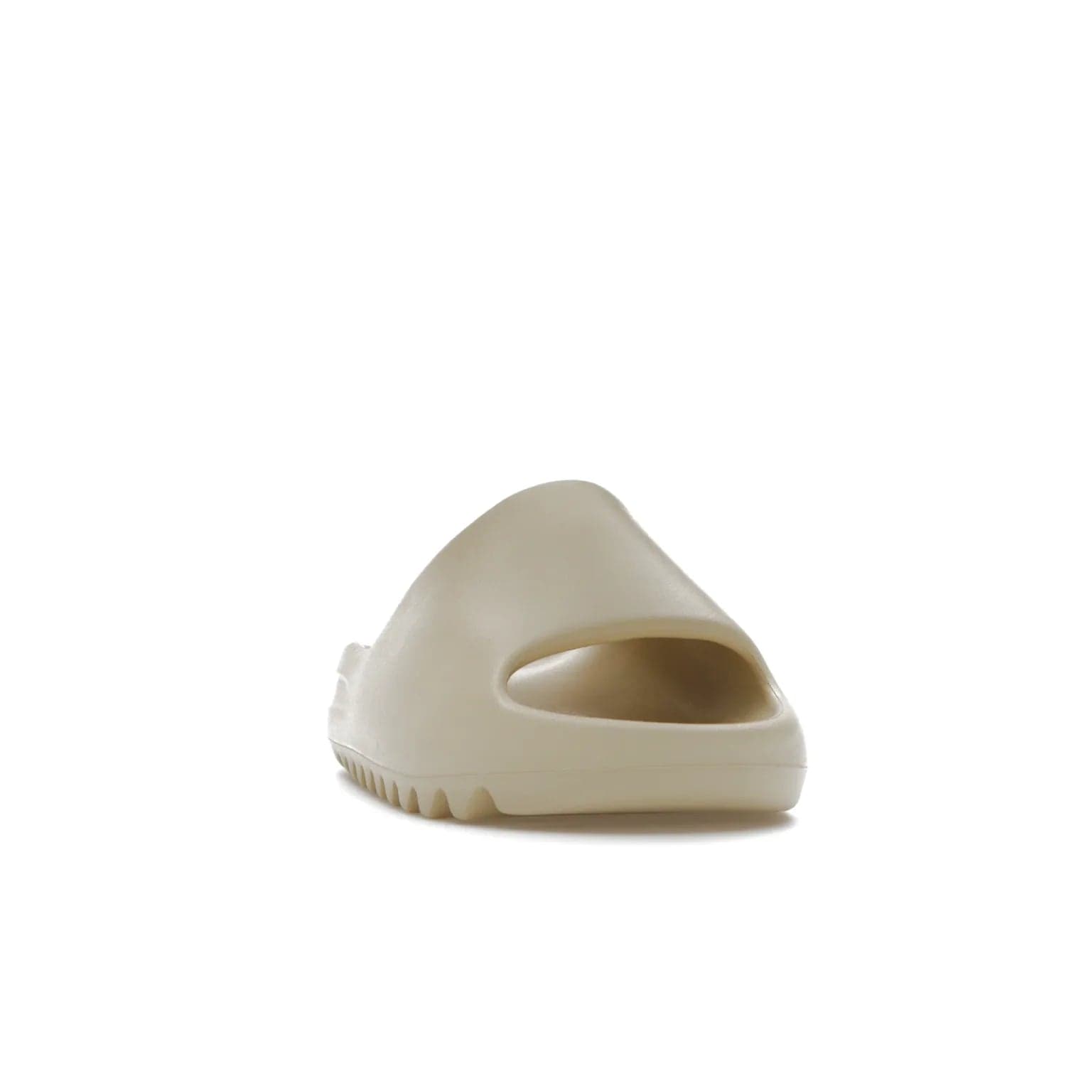 adidas Yeezy Slide Bone (2022 Restock) - Image 8 - Only at www.BallersClubKickz.com - Stay comfy with the adidas Yeezy Slide Bone - a fashionable silhouette with all-day comfort. This Bone/Bone/Bone colorway combines style and comfort with a pebbled texture and grooved sole. Restocked in May 2022, this shoe is the perfect addition to your collection.