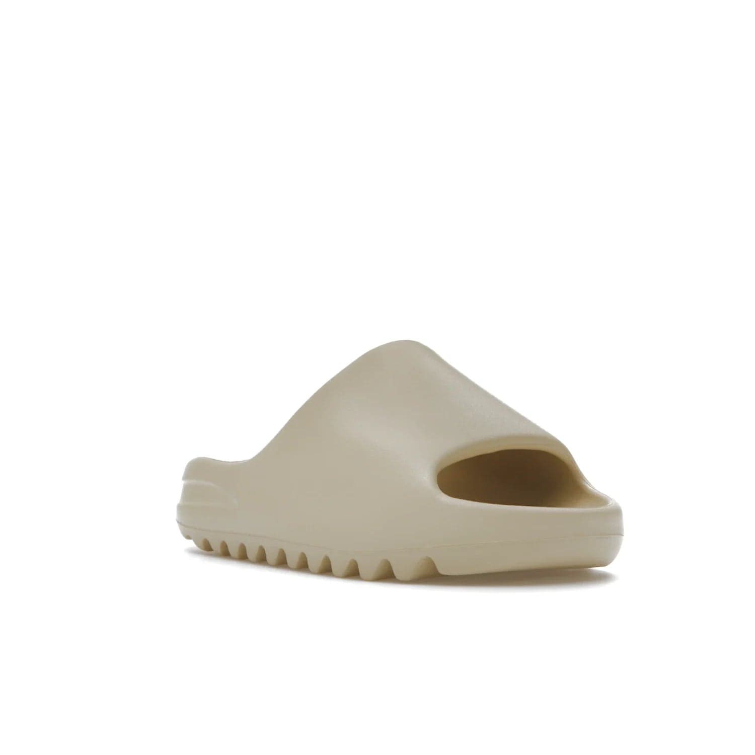 adidas Yeezy Slide Bone (2022 Restock) - Image 6 - Only at www.BallersClubKickz.com - Stay comfy with the adidas Yeezy Slide Bone - a fashionable silhouette with all-day comfort. This Bone/Bone/Bone colorway combines style and comfort with a pebbled texture and grooved sole. Restocked in May 2022, this shoe is the perfect addition to your collection.