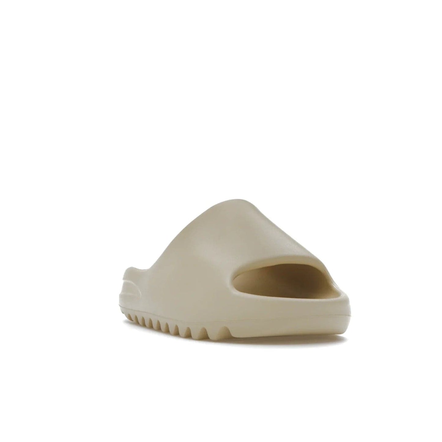adidas Yeezy Slide Bone (2022 Restock) - Image 7 - Only at www.BallersClubKickz.com - Stay comfy with the adidas Yeezy Slide Bone - a fashionable silhouette with all-day comfort. This Bone/Bone/Bone colorway combines style and comfort with a pebbled texture and grooved sole. Restocked in May 2022, this shoe is the perfect addition to your collection.