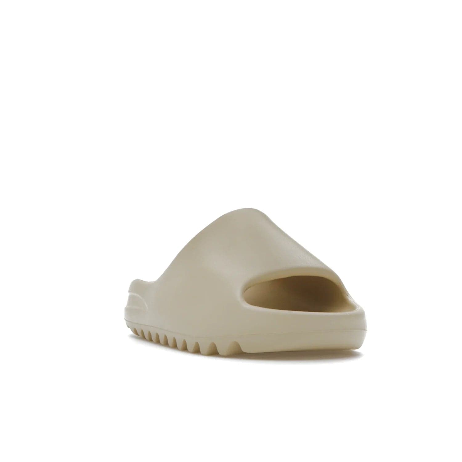 adidas Yeezy Slide Bone (2022 Restock) - Image 7 - Only at www.BallersClubKickz.com - Stay comfy with the adidas Yeezy Slide Bone - a fashionable silhouette with all-day comfort. This Bone/Bone/Bone colorway combines style and comfort with a pebbled texture and grooved sole. Restocked in May 2022, this shoe is the perfect addition to your collection.