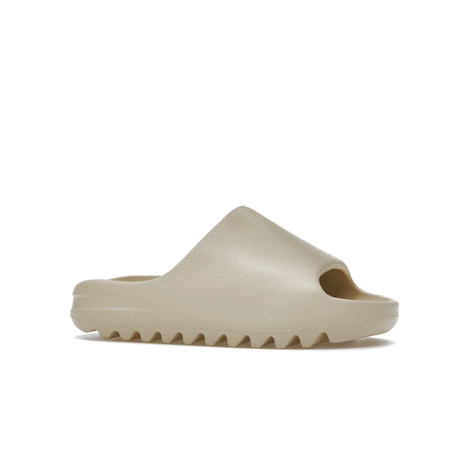 adidas Yeezy Slide Bone (2022 Restock) - Image 3 - Only at www.BallersClubKickz.com - Stay comfy with the adidas Yeezy Slide Bone - a fashionable silhouette with all-day comfort. This Bone/Bone/Bone colorway combines style and comfort with a pebbled texture and grooved sole. Restocked in May 2022, this shoe is the perfect addition to your collection.