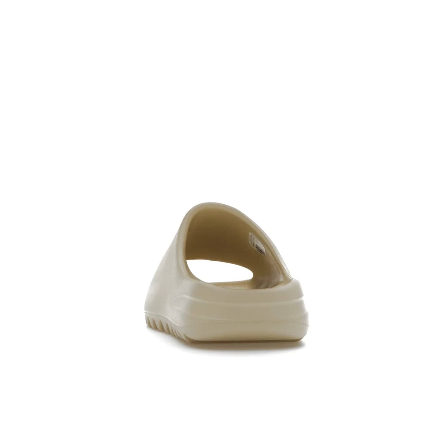 adidas Yeezy Slide Bone (2022 Restock) - Image 27 - Only at www.BallersClubKickz.com - Stay comfy with the adidas Yeezy Slide Bone - a fashionable silhouette with all-day comfort. This Bone/Bone/Bone colorway combines style and comfort with a pebbled texture and grooved sole. Restocked in May 2022, this shoe is the perfect addition to your collection.