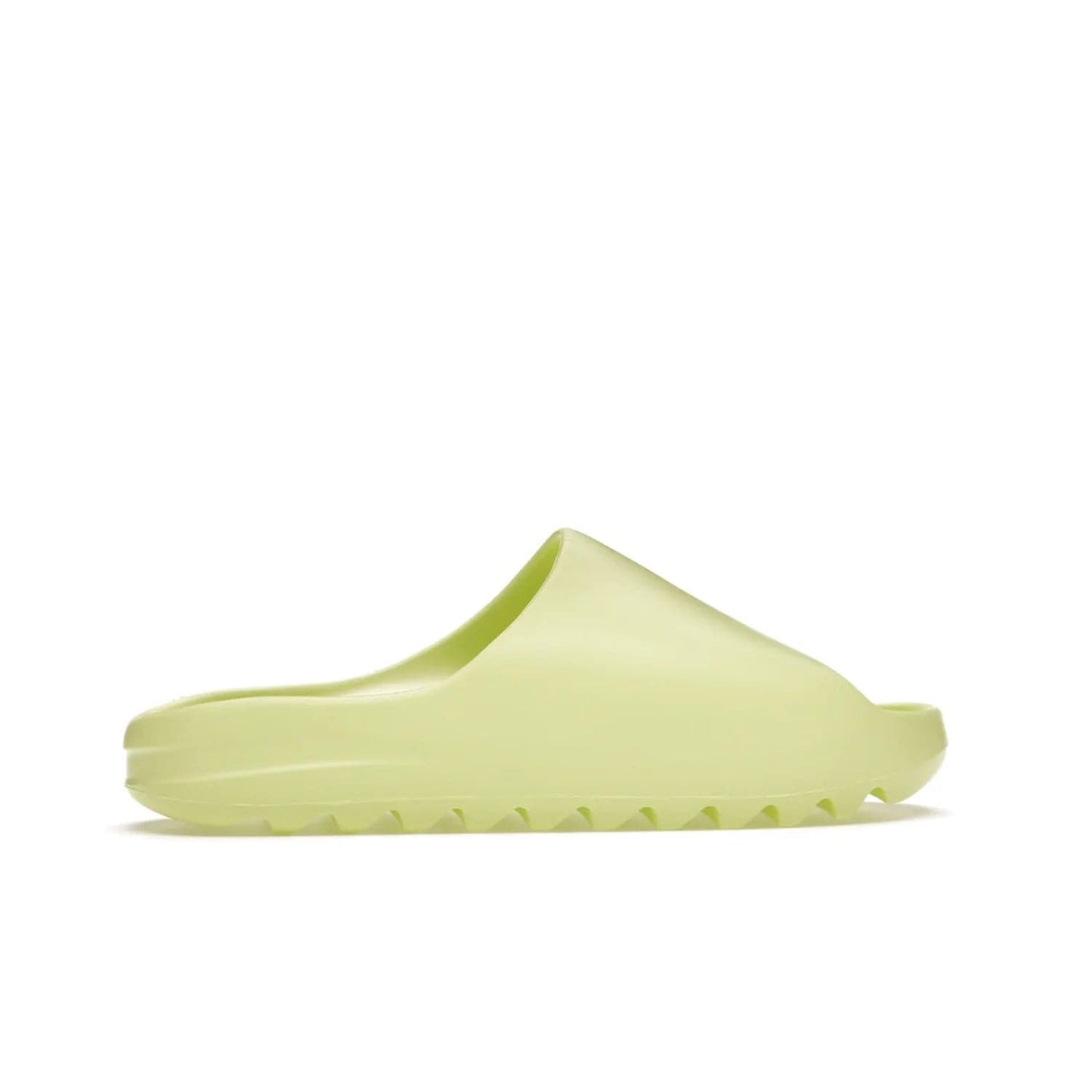 adidas Yeezy Slide Glow Green - Image 36 - Only at www.BallersClubKickz.com - Experience an unexpected summer style with the adidas Yeezy Slide Glow Green. This limited edition slide sandal provides a lightweight and durable construction and a bold Glow Green hue. Strategic grooves enhance traction and provide all-day comfort. Make a statement with the adidas Yeezy Slide Glow Green.