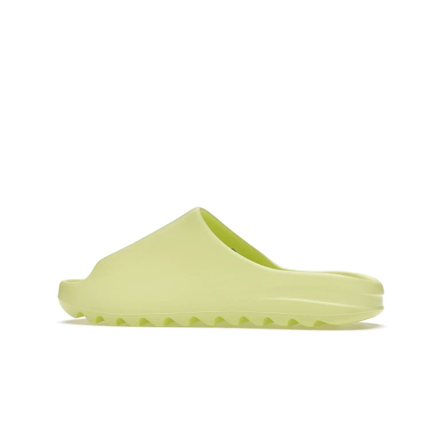adidas Yeezy Slide Glow Green - Image 21 - Only at www.BallersClubKickz.com - Experience an unexpected summer style with the adidas Yeezy Slide Glow Green. This limited edition slide sandal provides a lightweight and durable construction and a bold Glow Green hue. Strategic grooves enhance traction and provide all-day comfort. Make a statement with the adidas Yeezy Slide Glow Green.