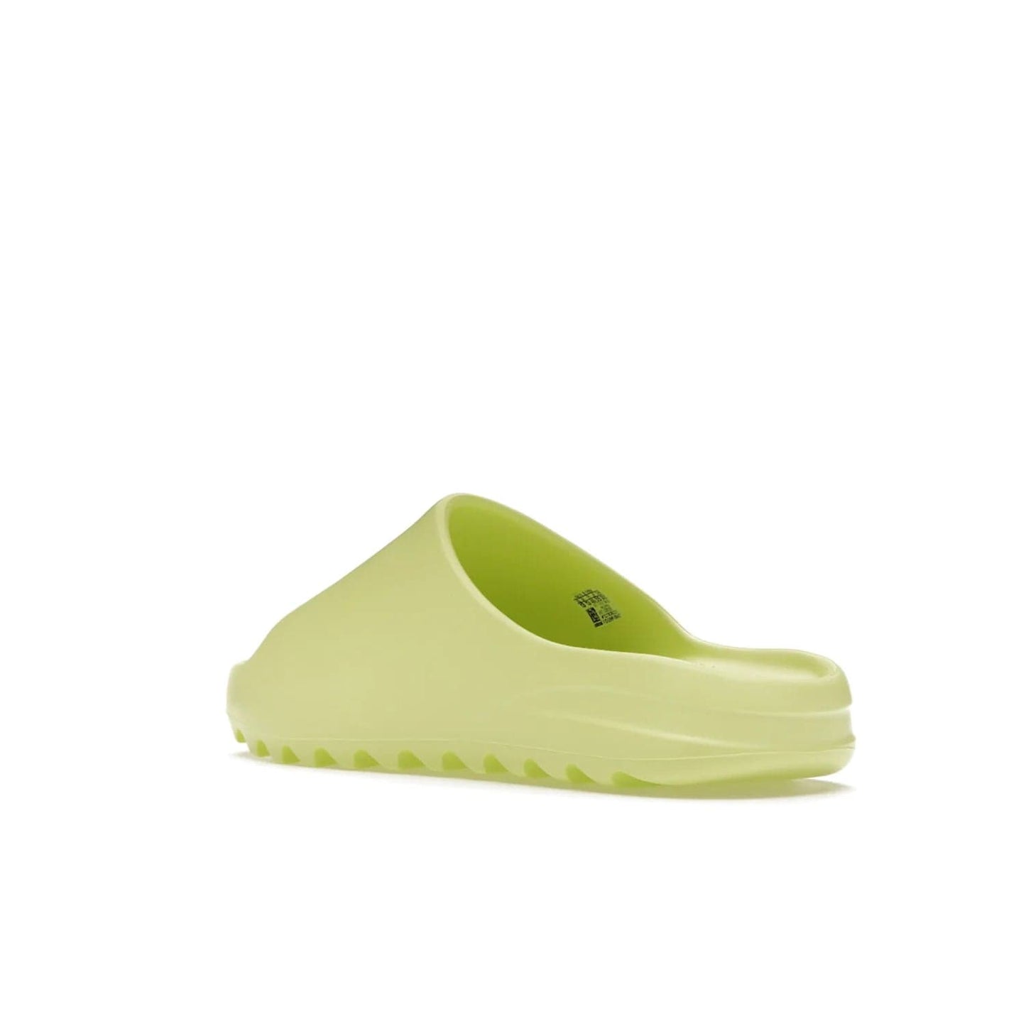 adidas Yeezy Slide Glow Green - Image 24 - Only at www.BallersClubKickz.com - Experience an unexpected summer style with the adidas Yeezy Slide Glow Green. This limited edition slide sandal provides a lightweight and durable construction and a bold Glow Green hue. Strategic grooves enhance traction and provide all-day comfort. Make a statement with the adidas Yeezy Slide Glow Green.