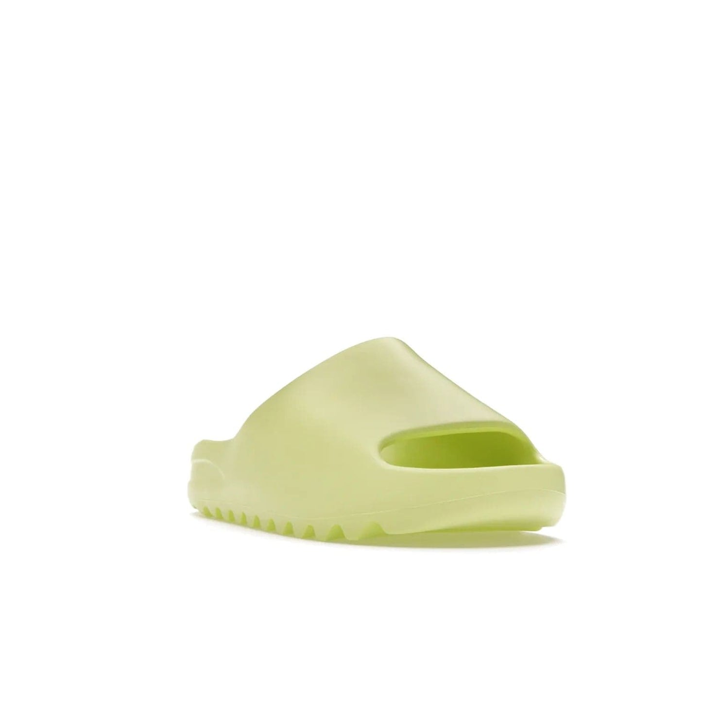 adidas Yeezy Slide Glow Green - Image 7 - Only at www.BallersClubKickz.com - Experience an unexpected summer style with the adidas Yeezy Slide Glow Green. This limited edition slide sandal provides a lightweight and durable construction and a bold Glow Green hue. Strategic grooves enhance traction and provide all-day comfort. Make a statement with the adidas Yeezy Slide Glow Green.