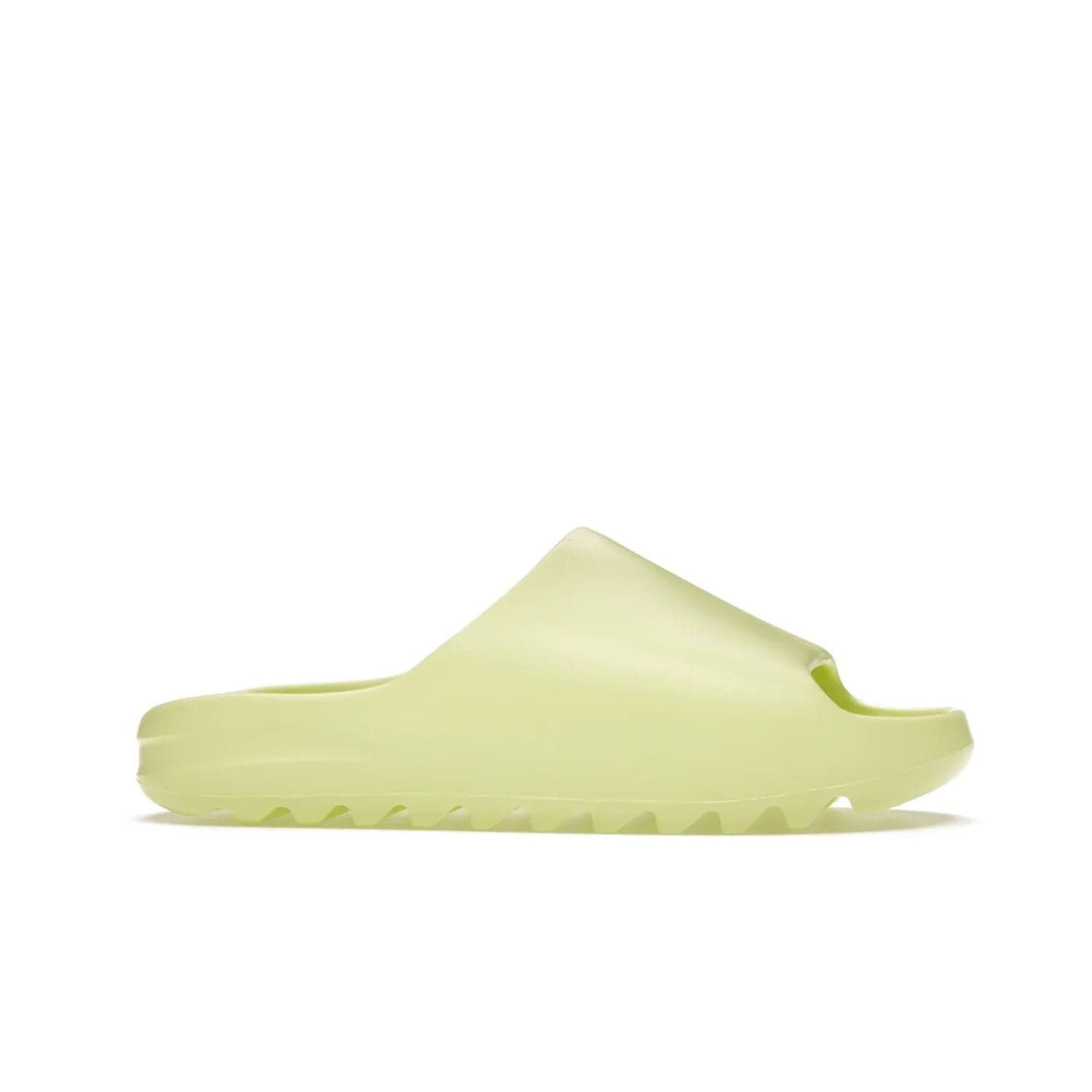 adidas Yeezy Slide Glow Green - Image 2 - Only at www.BallersClubKickz.com - Experience an unexpected summer style with the adidas Yeezy Slide Glow Green. This limited edition slide sandal provides a lightweight and durable construction and a bold Glow Green hue. Strategic grooves enhance traction and provide all-day comfort. Make a statement with the adidas Yeezy Slide Glow Green.