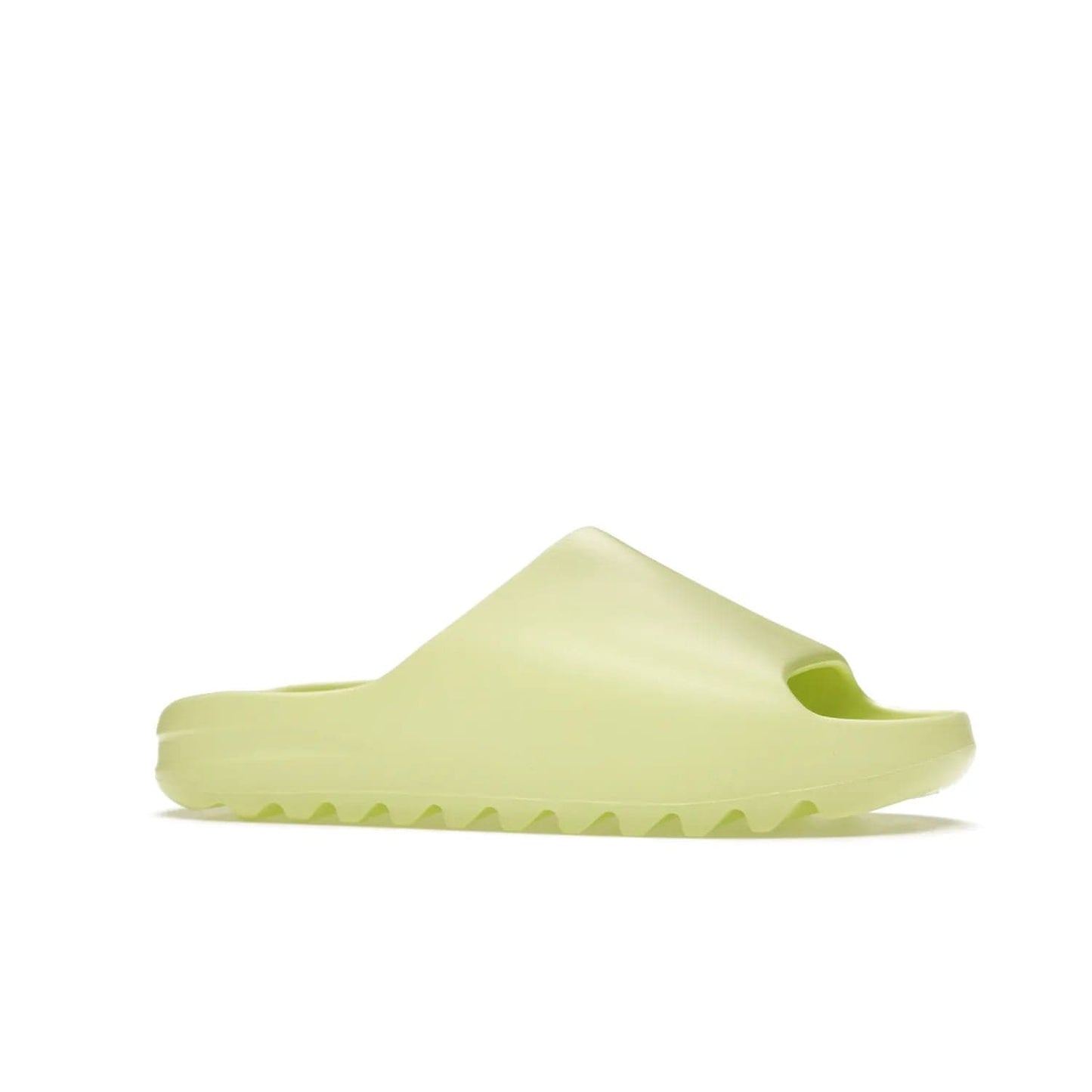 adidas Yeezy Slide Glow Green - Image 3 - Only at www.BallersClubKickz.com - Experience an unexpected summer style with the adidas Yeezy Slide Glow Green. This limited edition slide sandal provides a lightweight and durable construction and a bold Glow Green hue. Strategic grooves enhance traction and provide all-day comfort. Make a statement with the adidas Yeezy Slide Glow Green.
