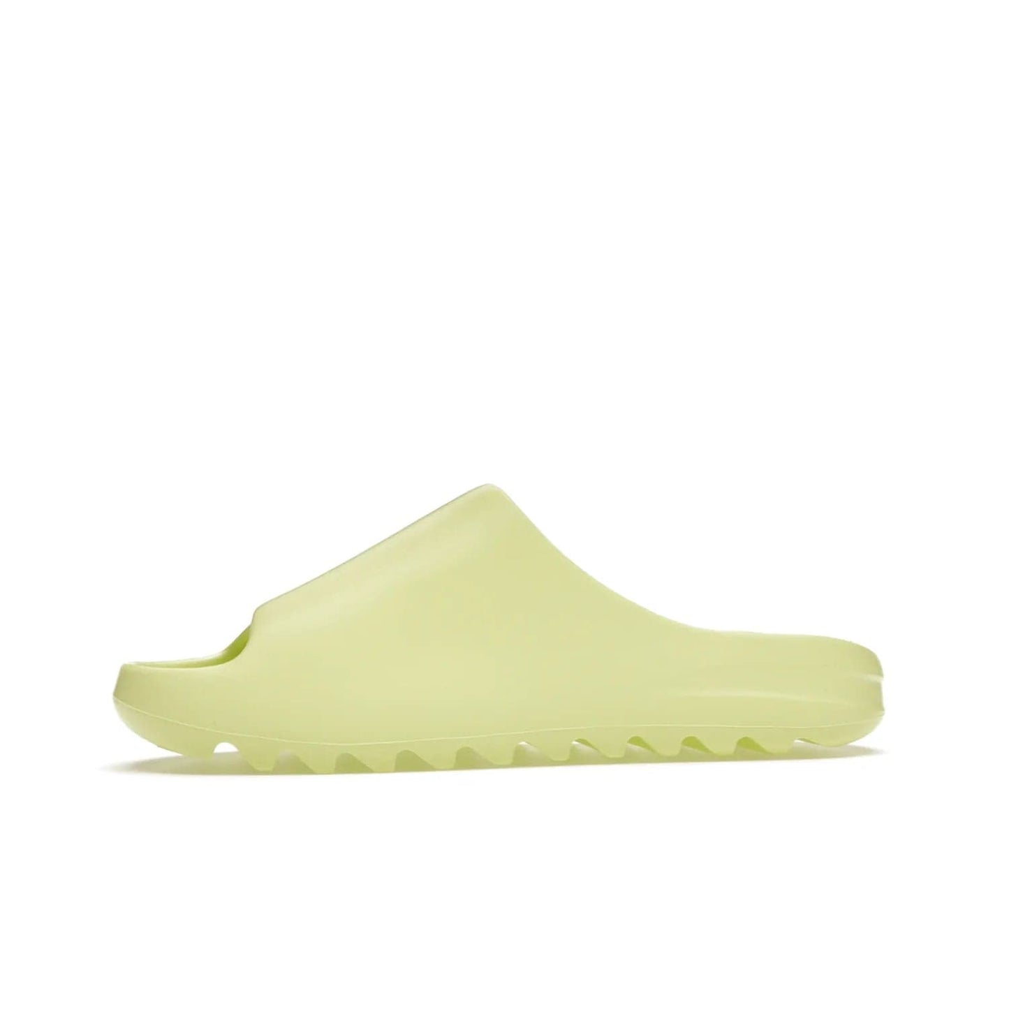 adidas Yeezy Slide Glow Green - Image 18 - Only at www.BallersClubKickz.com - Experience an unexpected summer style with the adidas Yeezy Slide Glow Green. This limited edition slide sandal provides a lightweight and durable construction and a bold Glow Green hue. Strategic grooves enhance traction and provide all-day comfort. Make a statement with the adidas Yeezy Slide Glow Green.