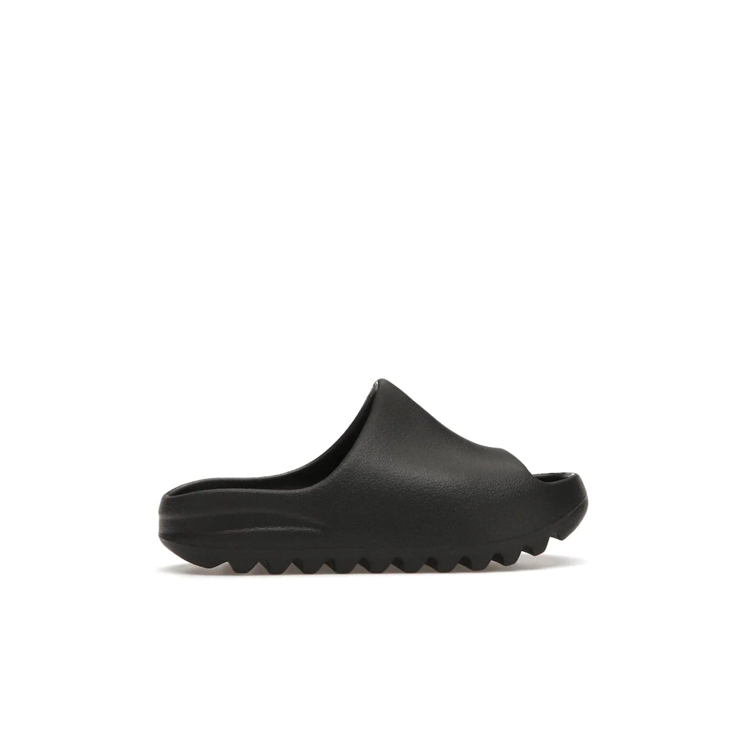 adidas Yeezy Slide Onyx (Kids) - Image 36 - Only at www.BallersClubKickz.com - adidas Yeezy Slide Onyx (Kids): Comfortable foam construction with textured surface and iconic three-stripe logo. Breathable, open-toe design and deep grooves for traction. Released in March 2021 at $50.