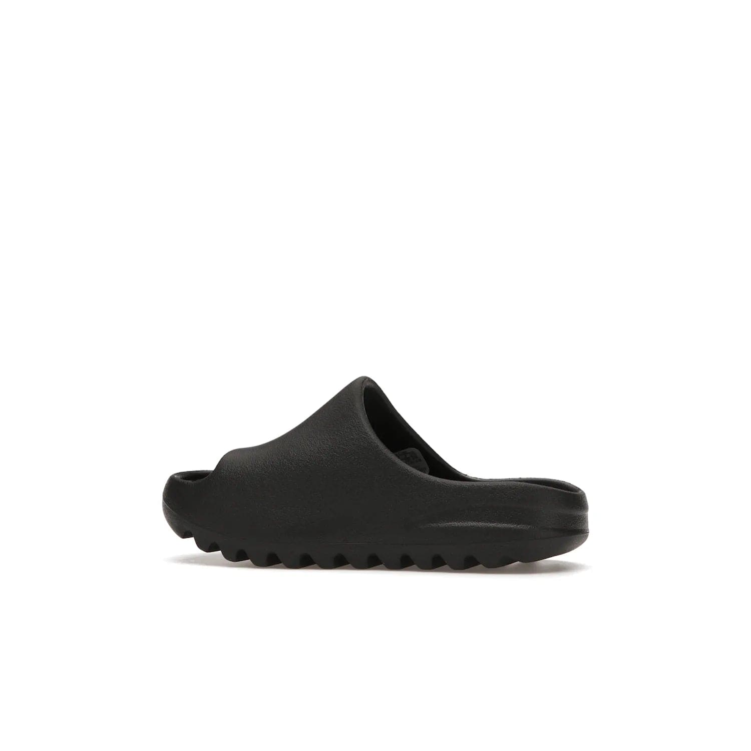 adidas Yeezy Slide Onyx (Kids) - Image 21 - Only at www.BallersClubKickz.com - adidas Yeezy Slide Onyx (Kids): Comfortable foam construction with textured surface and iconic three-stripe logo. Breathable, open-toe design and deep grooves for traction. Released in March 2021 at $50.