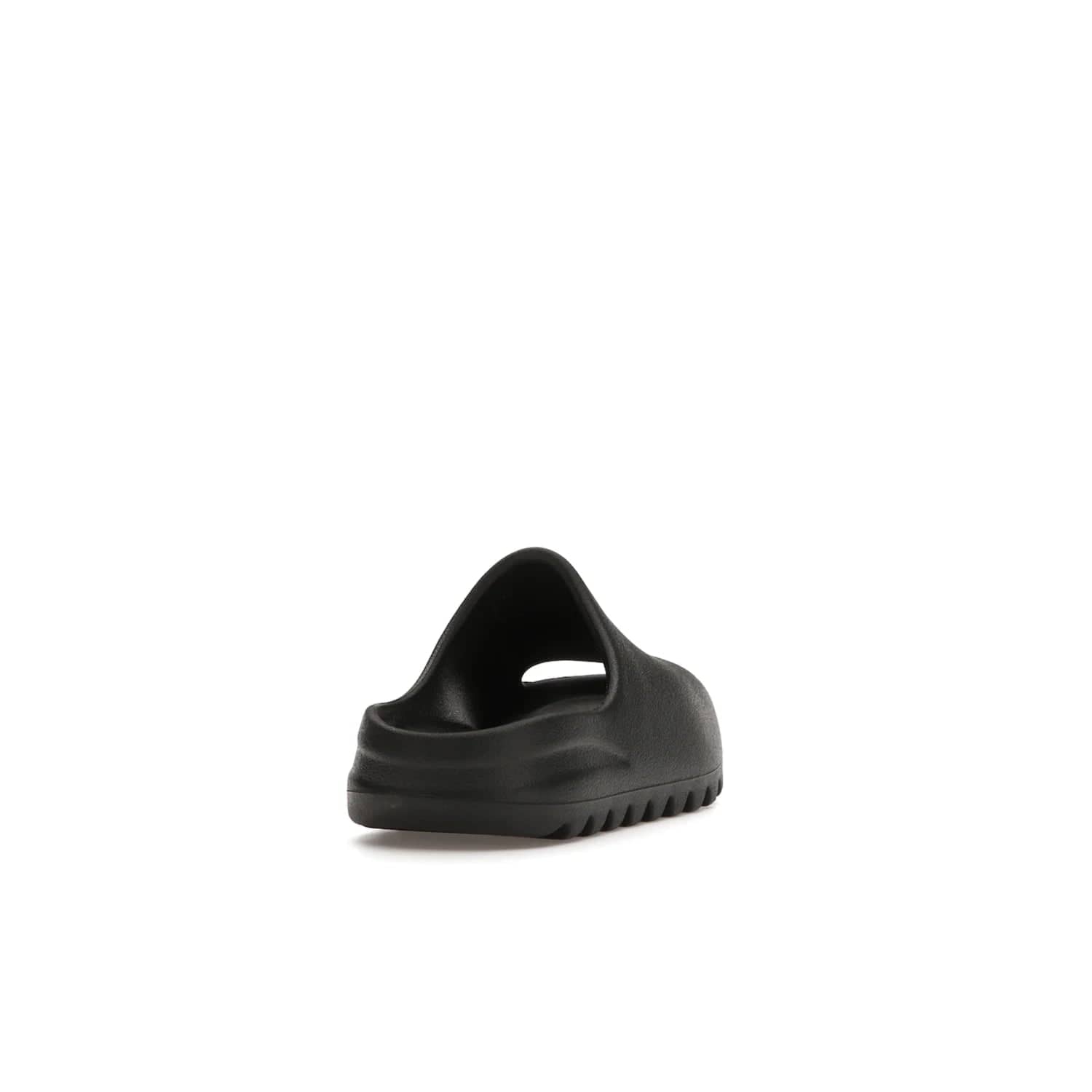 adidas Yeezy Slide Onyx (Kids) - Image 30 - Only at www.BallersClubKickz.com - adidas Yeezy Slide Onyx (Kids): Comfortable foam construction with textured surface and iconic three-stripe logo. Breathable, open-toe design and deep grooves for traction. Released in March 2021 at $50.