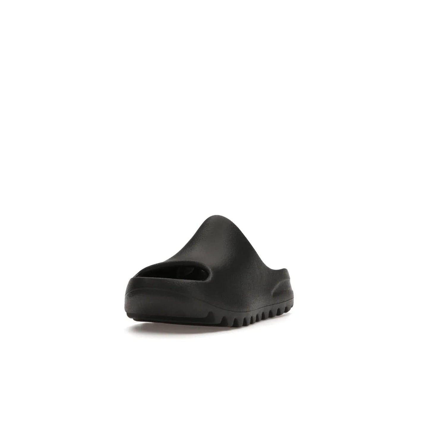 adidas Yeezy Slide Onyx (Kids) - Image 13 - Only at www.BallersClubKickz.com - adidas Yeezy Slide Onyx (Kids): Comfortable foam construction with textured surface and iconic three-stripe logo. Breathable, open-toe design and deep grooves for traction. Released in March 2021 at $50.