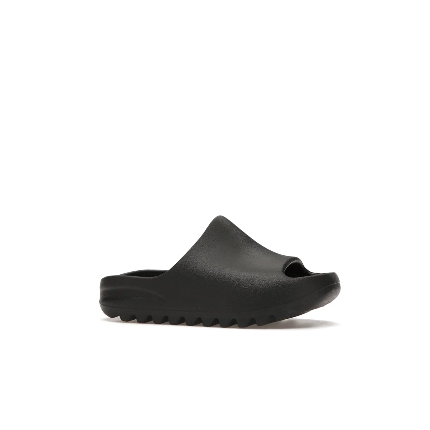 adidas Yeezy Slide Onyx (Kids) - Image 3 - Only at www.BallersClubKickz.com - adidas Yeezy Slide Onyx (Kids): Comfortable foam construction with textured surface and iconic three-stripe logo. Breathable, open-toe design and deep grooves for traction. Released in March 2021 at $50.