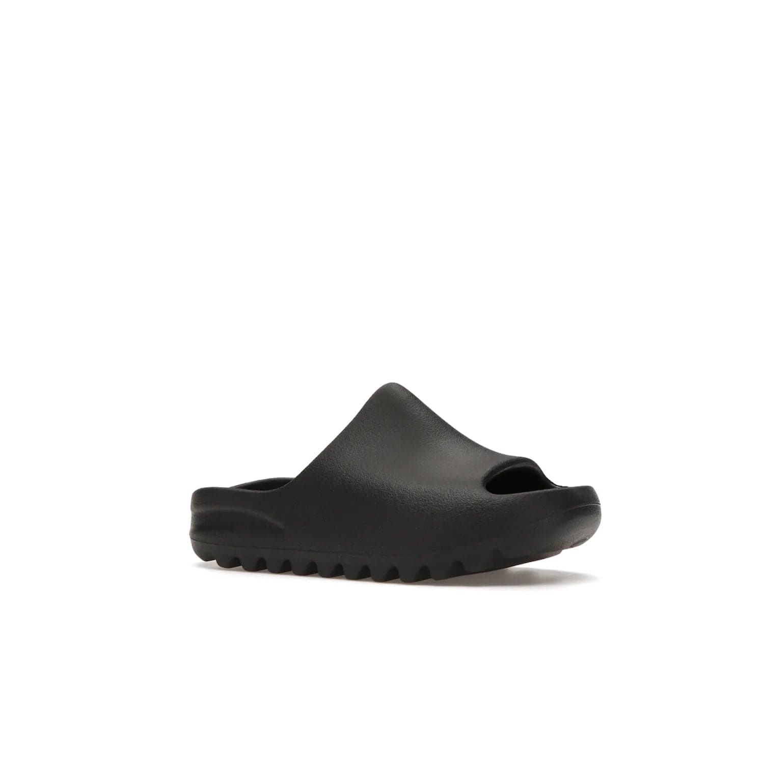 adidas Yeezy Slide Onyx (Kids) - Image 4 - Only at www.BallersClubKickz.com - adidas Yeezy Slide Onyx (Kids): Comfortable foam construction with textured surface and iconic three-stripe logo. Breathable, open-toe design and deep grooves for traction. Released in March 2021 at $50.