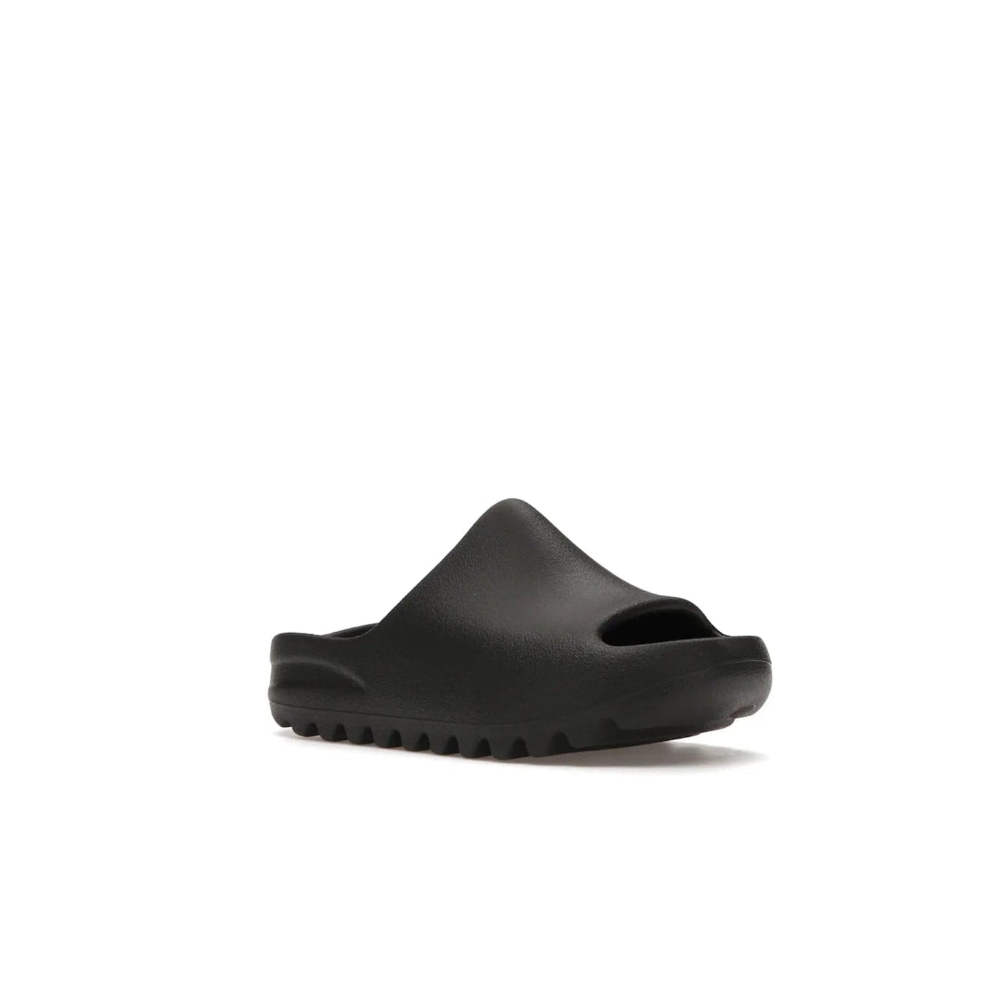 adidas Yeezy Slide Onyx (Kids) - Image 5 - Only at www.BallersClubKickz.com - adidas Yeezy Slide Onyx (Kids): Comfortable foam construction with textured surface and iconic three-stripe logo. Breathable, open-toe design and deep grooves for traction. Released in March 2021 at $50.