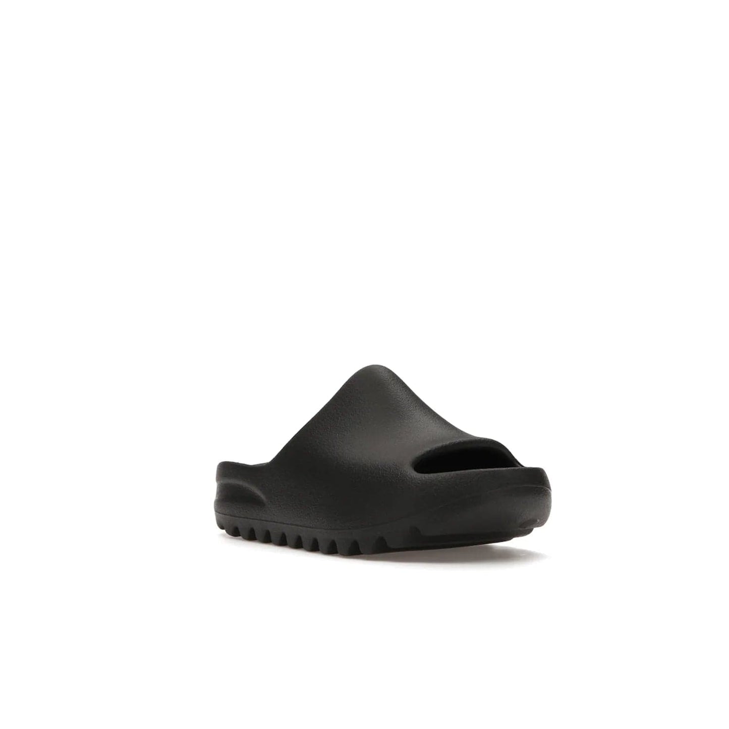 adidas Yeezy Slide Onyx (Kids) - Image 6 - Only at www.BallersClubKickz.com - adidas Yeezy Slide Onyx (Kids): Comfortable foam construction with textured surface and iconic three-stripe logo. Breathable, open-toe design and deep grooves for traction. Released in March 2021 at $50.
