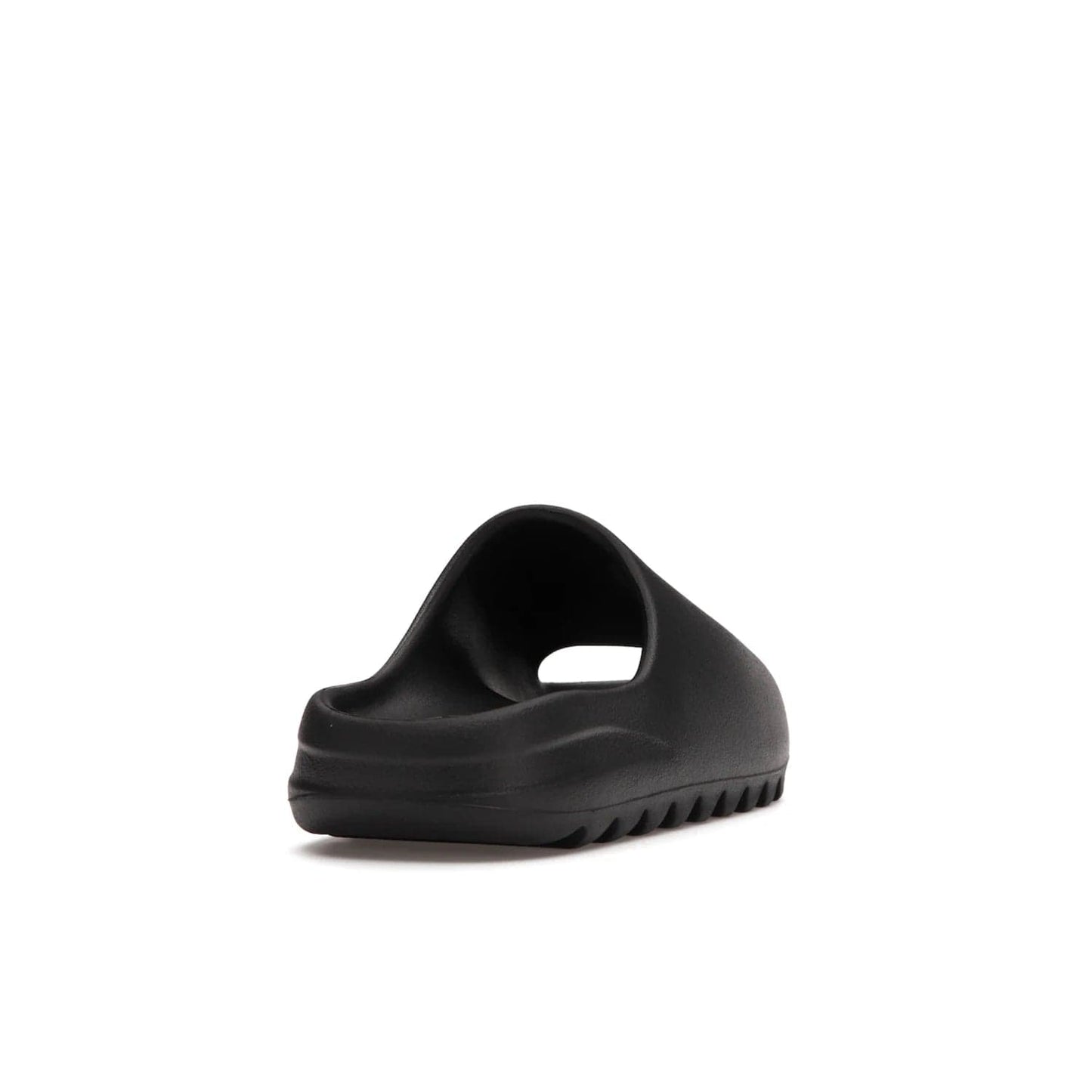 adidas Yeezy Slide Onyx - Image 30 - Only at www.BallersClubKickz.com - Step into comfort and style with the adidas Yeezy Slide Onyx. Featuring foam construction, an all-black colorway and a grooved outsole for stability and responsiveness, this versatile slide is a must-have for your collection.