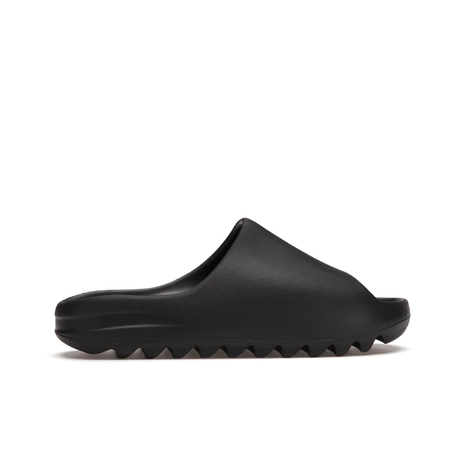 adidas Yeezy Slide Onyx - Image 36 - Only at www.BallersClubKickz.com - Step into comfort and style with the adidas Yeezy Slide Onyx. Featuring foam construction, an all-black colorway and a grooved outsole for stability and responsiveness, this versatile slide is a must-have for your collection.