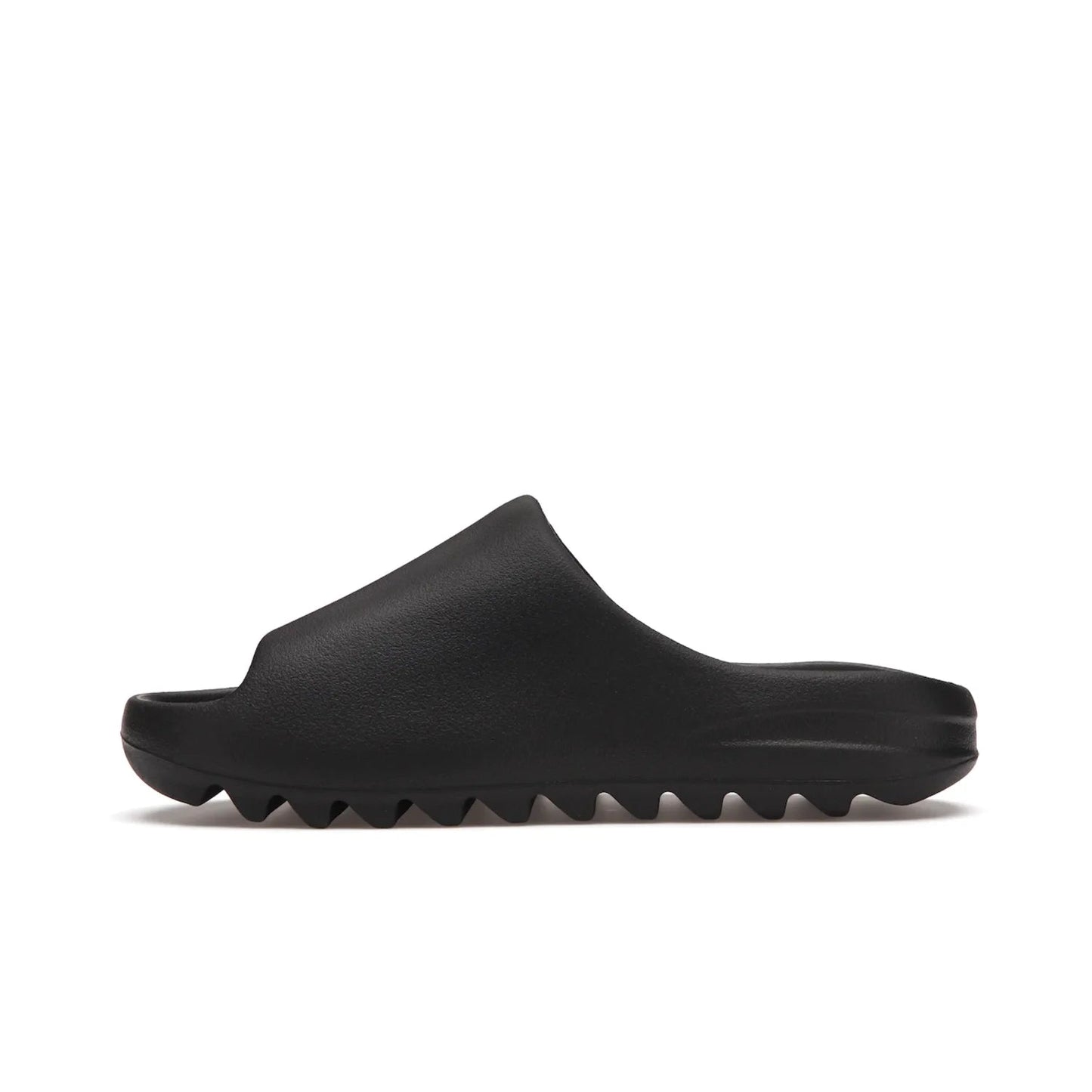 adidas Yeezy Slide Onyx - Image 19 - Only at www.BallersClubKickz.com - Step into comfort and style with the adidas Yeezy Slide Onyx. Featuring foam construction, an all-black colorway and a grooved outsole for stability and responsiveness, this versatile slide is a must-have for your collection.