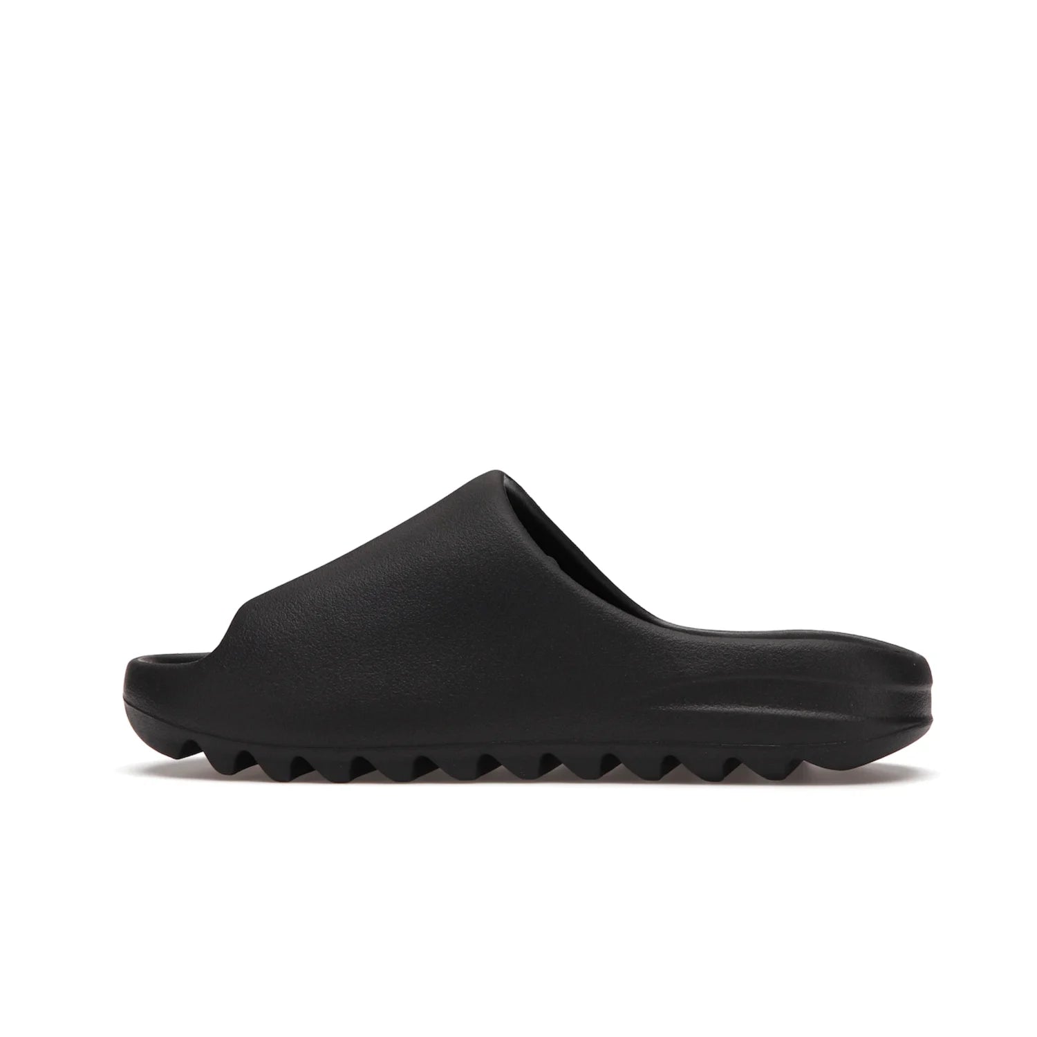 adidas Yeezy Slide Onyx - Image 20 - Only at www.BallersClubKickz.com - Step into comfort and style with the adidas Yeezy Slide Onyx. Featuring foam construction, an all-black colorway and a grooved outsole for stability and responsiveness, this versatile slide is a must-have for your collection.