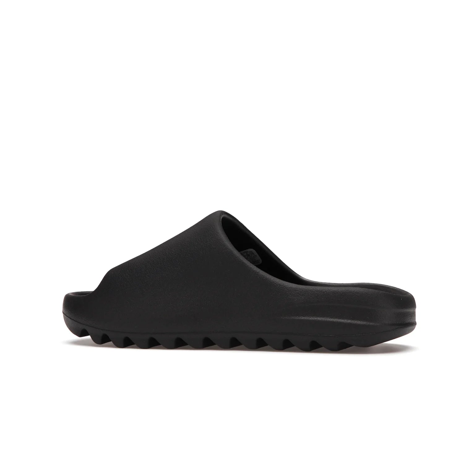adidas Yeezy Slide Onyx - Image 21 - Only at www.BallersClubKickz.com - Step into comfort and style with the adidas Yeezy Slide Onyx. Featuring foam construction, an all-black colorway and a grooved outsole for stability and responsiveness, this versatile slide is a must-have for your collection.