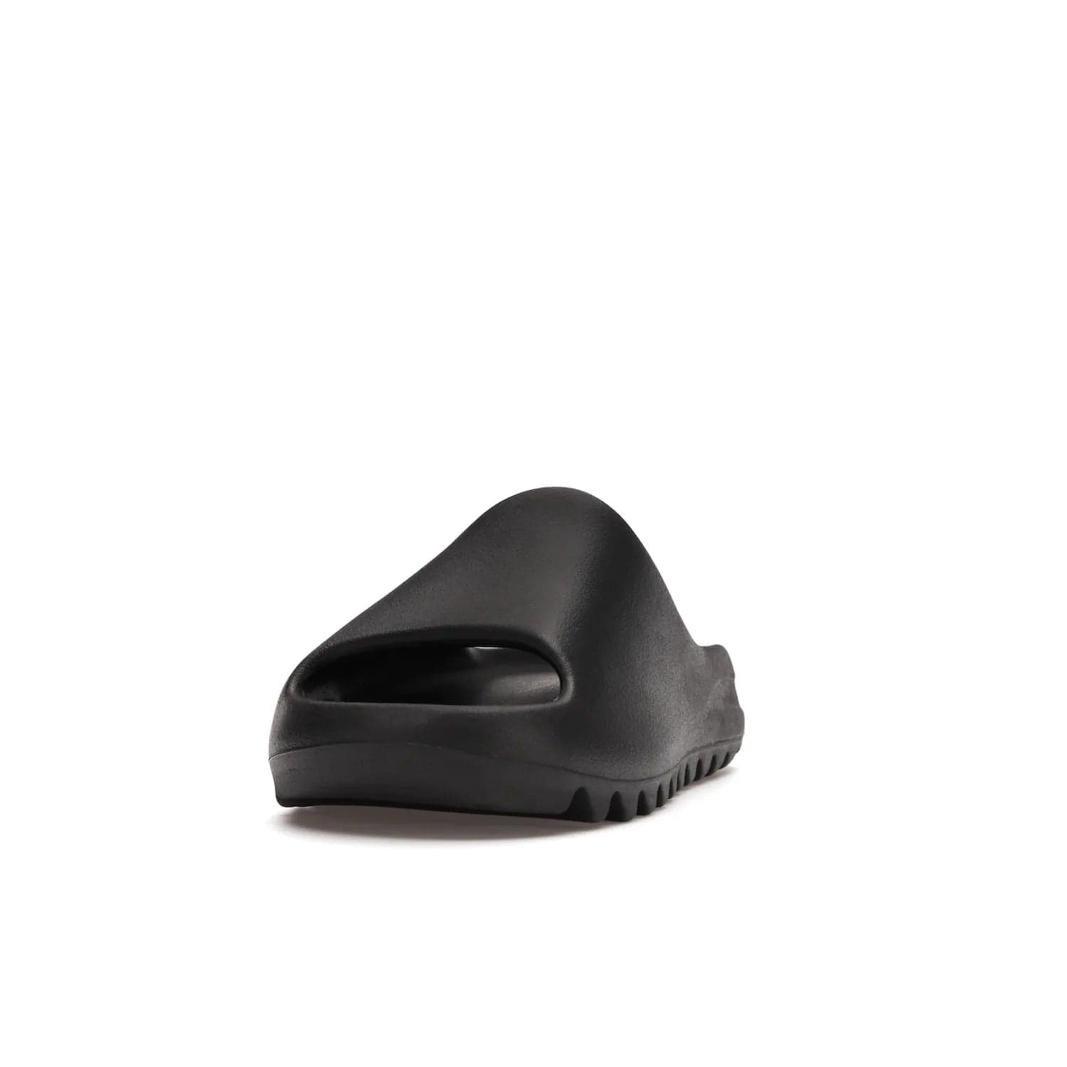 adidas Yeezy Slide Onyx - Image 12 - Only at www.BallersClubKickz.com - Step into comfort and style with the adidas Yeezy Slide Onyx. Featuring foam construction, an all-black colorway and a grooved outsole for stability and responsiveness, this versatile slide is a must-have for your collection.