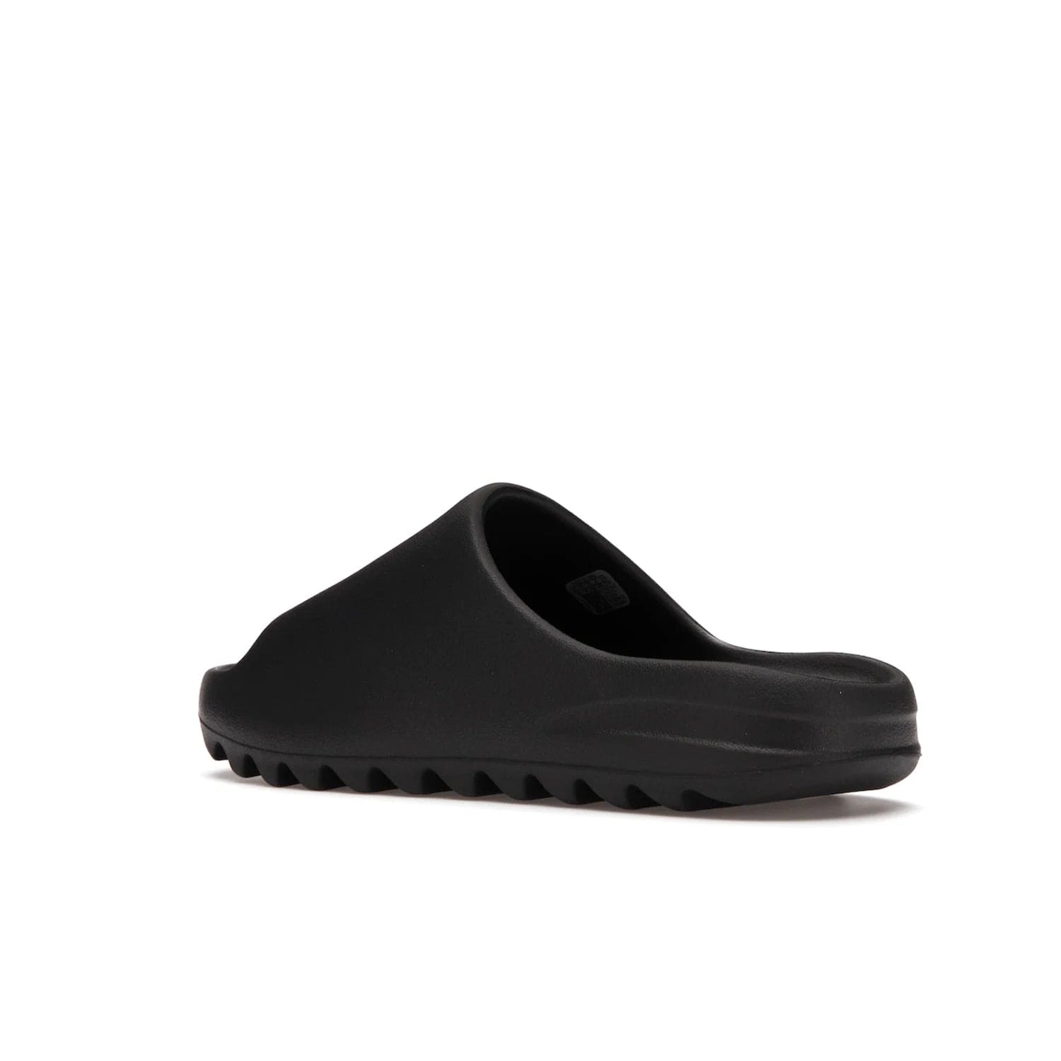 adidas Yeezy Slide Onyx - Image 23 - Only at www.BallersClubKickz.com - Step into comfort and style with the adidas Yeezy Slide Onyx. Featuring foam construction, an all-black colorway and a grooved outsole for stability and responsiveness, this versatile slide is a must-have for your collection.