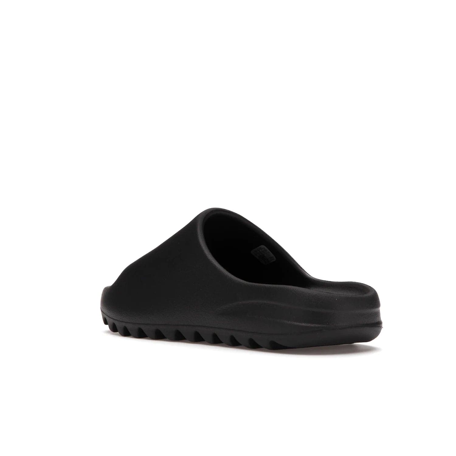 adidas Yeezy Slide Onyx - Image 24 - Only at www.BallersClubKickz.com - Step into comfort and style with the adidas Yeezy Slide Onyx. Featuring foam construction, an all-black colorway and a grooved outsole for stability and responsiveness, this versatile slide is a must-have for your collection.