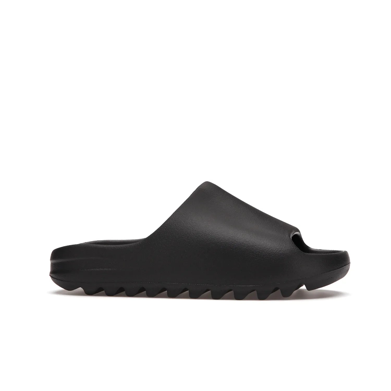adidas Yeezy Slide Onyx - Image 2 - Only at www.BallersClubKickz.com - Step into comfort and style with the adidas Yeezy Slide Onyx. Featuring foam construction, an all-black colorway and a grooved outsole for stability and responsiveness, this versatile slide is a must-have for your collection.