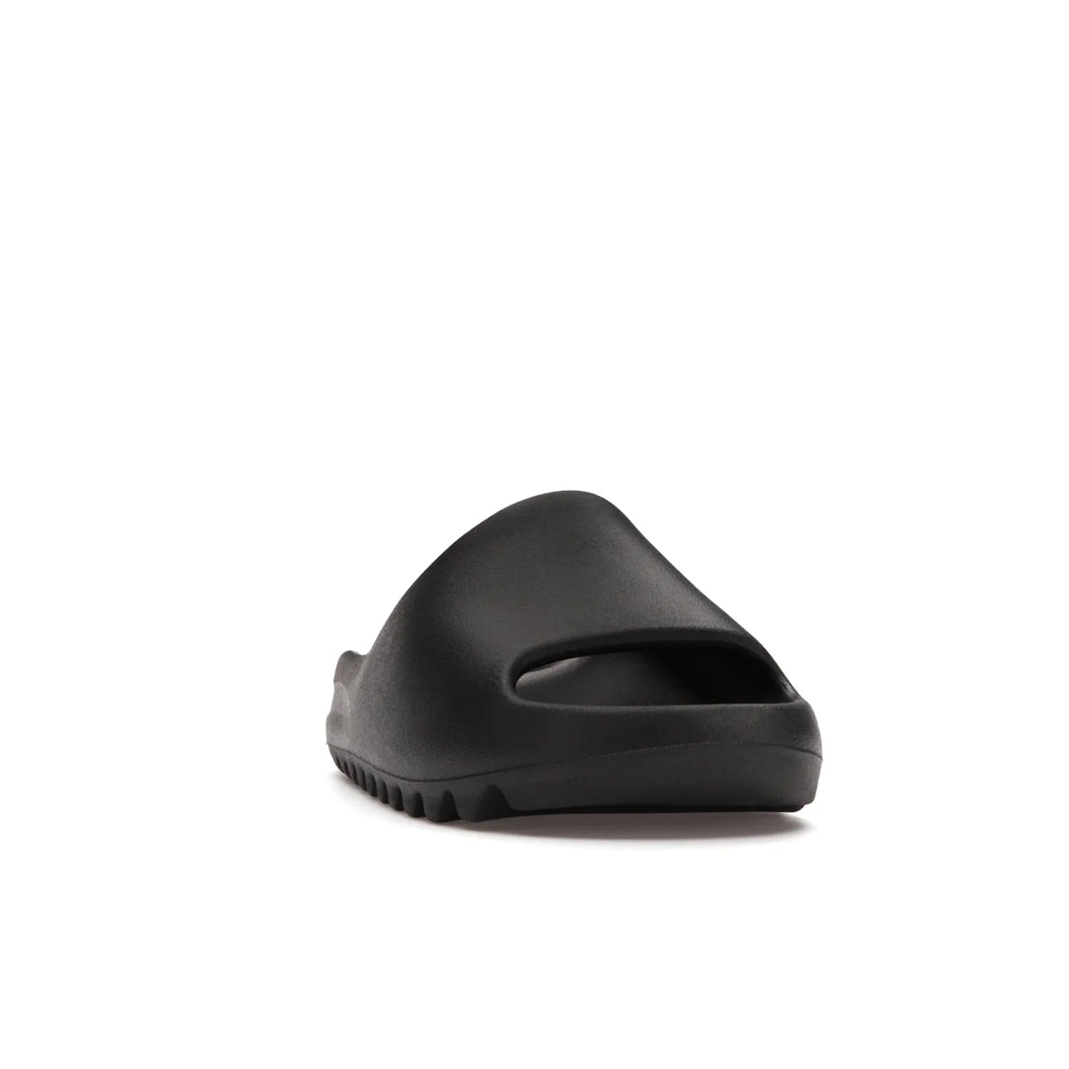 adidas Yeezy Slide Onyx - Image 8 - Only at www.BallersClubKickz.com - Step into comfort and style with the adidas Yeezy Slide Onyx. Featuring foam construction, an all-black colorway and a grooved outsole for stability and responsiveness, this versatile slide is a must-have for your collection.