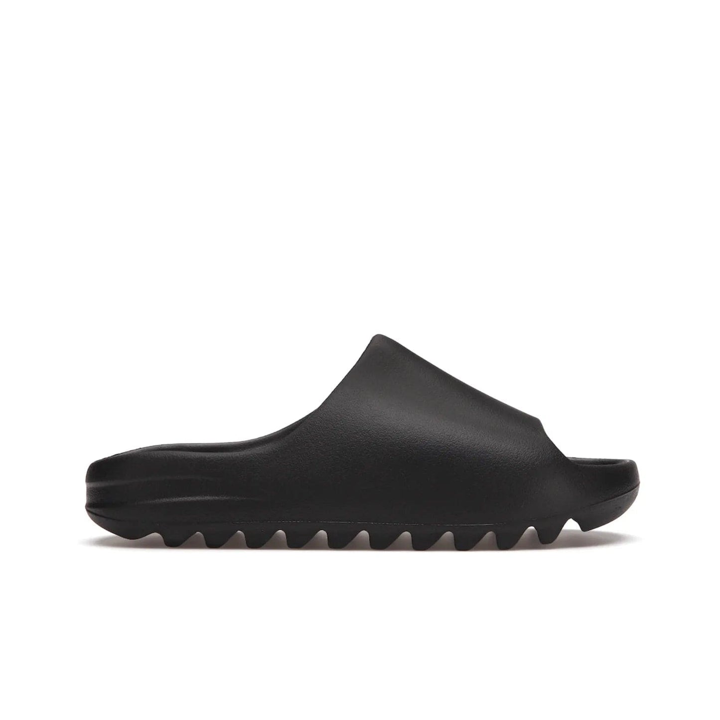 adidas Yeezy Slide Onyx - Image 1 - Only at www.BallersClubKickz.com - Step into comfort and style with the adidas Yeezy Slide Onyx. Featuring foam construction, an all-black colorway and a grooved outsole for stability and responsiveness, this versatile slide is a must-have for your collection.