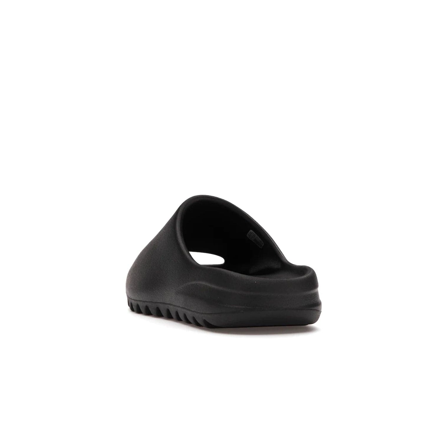 adidas Yeezy Slide Onyx - Image 26 - Only at www.BallersClubKickz.com - Step into comfort and style with the adidas Yeezy Slide Onyx. Featuring foam construction, an all-black colorway and a grooved outsole for stability and responsiveness, this versatile slide is a must-have for your collection.