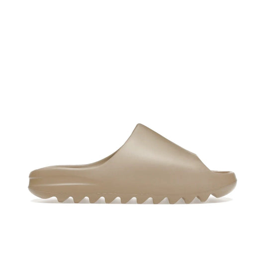 adidas Yeezy Slide Pure (First Release) - Image 1 - Only at www.BallersClubKickz.com - Shop the new adidas Yeezy Slide Pure at adidas. Crafted with a Pure EVA foam upper and soft footbed for instant comfort. Outsole with grooves offers traction & support for a perfect summer look. Available in Pure/Pure/Pure.