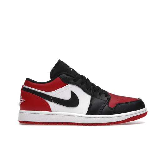 Jordan 1 Low Bred Toe - Image 1 - Only at www.BallersClubKickz.com - Step into the iconic Jordan 1 Retro. Mixing and matching of leather in red, black, and white makes for a unique colorway. Finished off with a Wing logo embroidery & Jumpman label. Comfortable and stylish at an affordable $100, the Jordan 1 Low Bred Toe is perfect for any true sneaker fan.