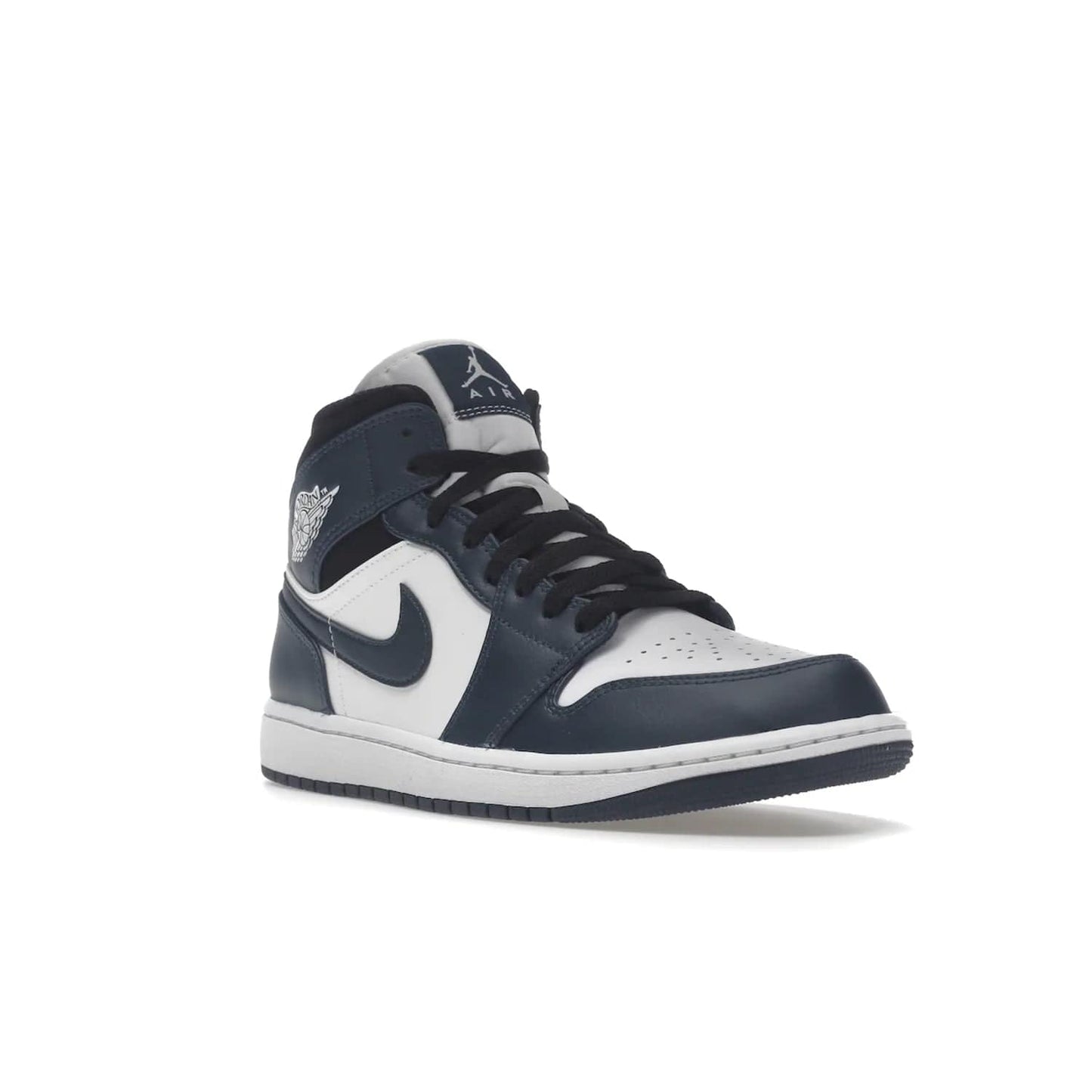 Jordan 1 Mid Armory Navy - Image 6 - Only at www.BallersClubKickz.com - The Jordan 1 Mid Armory Navy: classic basketball sneaker with soft white leather upper, deep navy blue overlays, and black leather ankle detailing. Iconic style with Jordan Wings logo and Jumpman label.