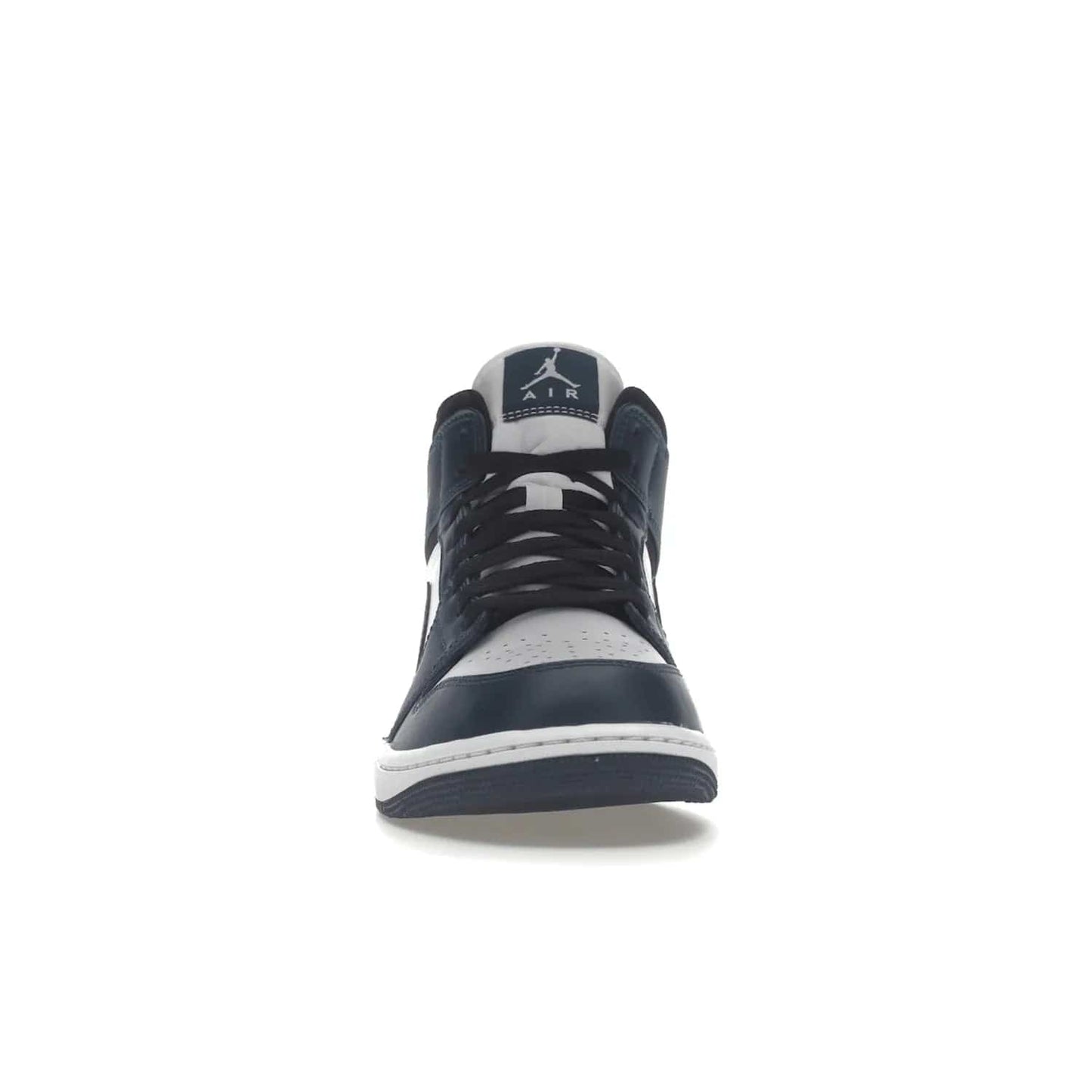 Jordan 1 Mid Armory Navy - Image 10 - Only at www.BallersClubKickz.com - The Jordan 1 Mid Armory Navy: classic basketball sneaker with soft white leather upper, deep navy blue overlays, and black leather ankle detailing. Iconic style with Jordan Wings logo and Jumpman label.