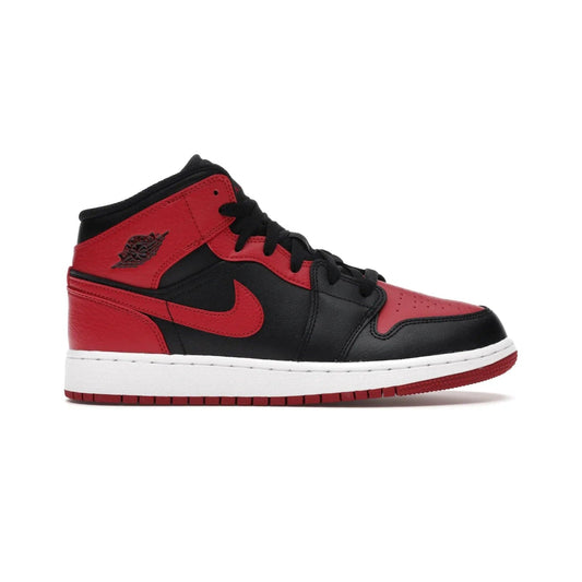 Jordan 1 Mid Banned (2020) (GS) - Image 1 - Only at www.BallersClubKickz.com - Introducing Kids Air Jordan 1 Mid Banned 2020: Michael Jordan's iconic signature shoe in a mid-top take with luxurious leather upper, black color palette & contrasting white midsole & red outsole. Released in Nov 2020 to wide fan reception.