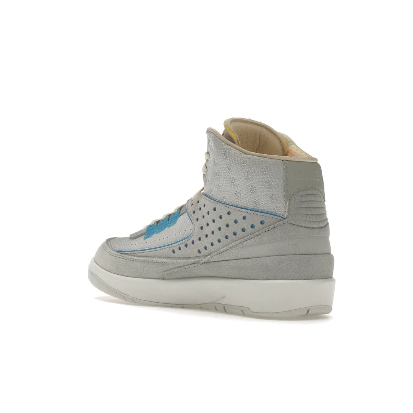 Jordan 2 Retro SP Union Grey Fog - Image 24 - Only at www.BallersClubKickz.com - Introducing the Air Jordan 2 Retro SP Union Grey Fog. This intricate sneaker design features a grey canvas upper with light blue eyelets, eyestay patches, and piping, plus custom external tags. Dropping in April 2022, this exclusive release offers a worn-in look and feel.