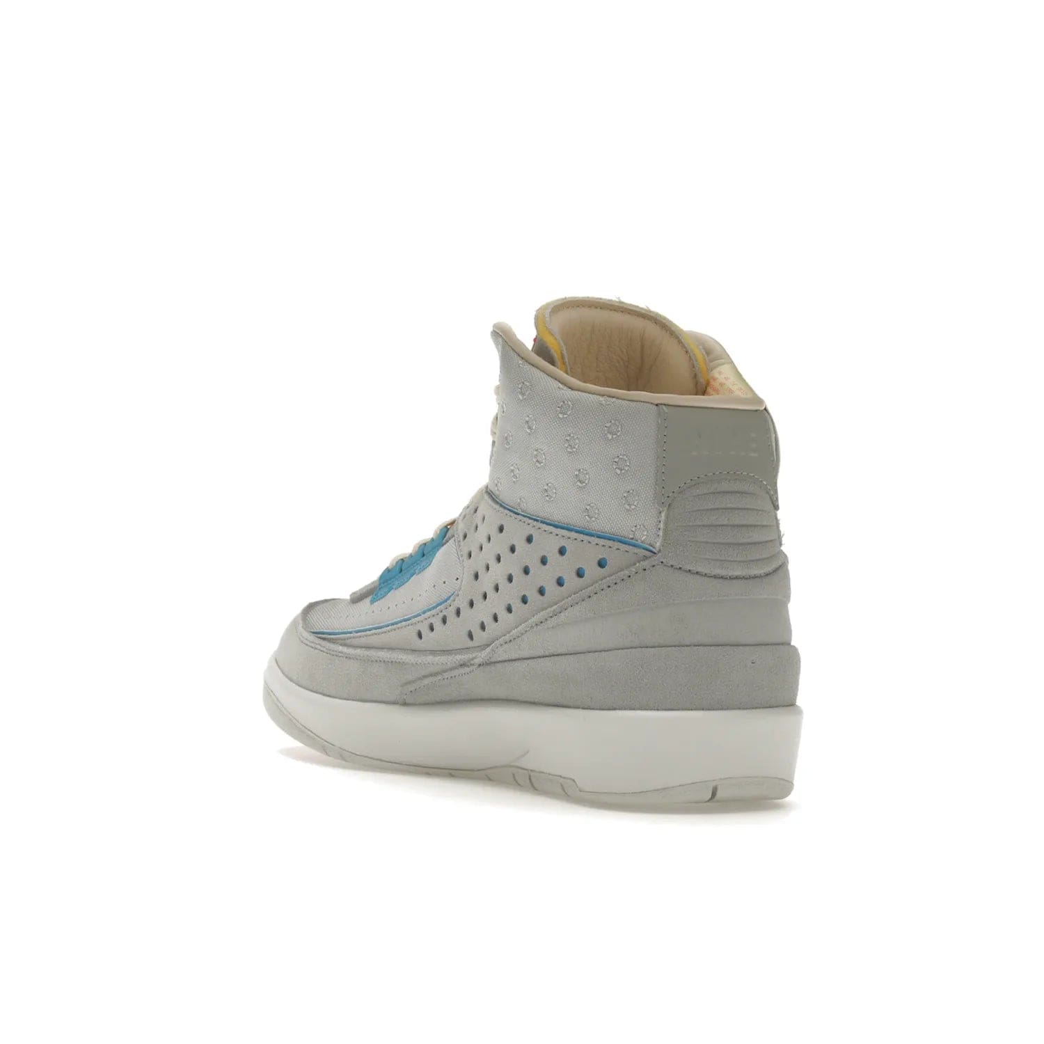 Jordan 2 Retro SP Union Grey Fog - Image 25 - Only at www.BallersClubKickz.com - Introducing the Air Jordan 2 Retro SP Union Grey Fog. This intricate sneaker design features a grey canvas upper with light blue eyelets, eyestay patches, and piping, plus custom external tags. Dropping in April 2022, this exclusive release offers a worn-in look and feel.