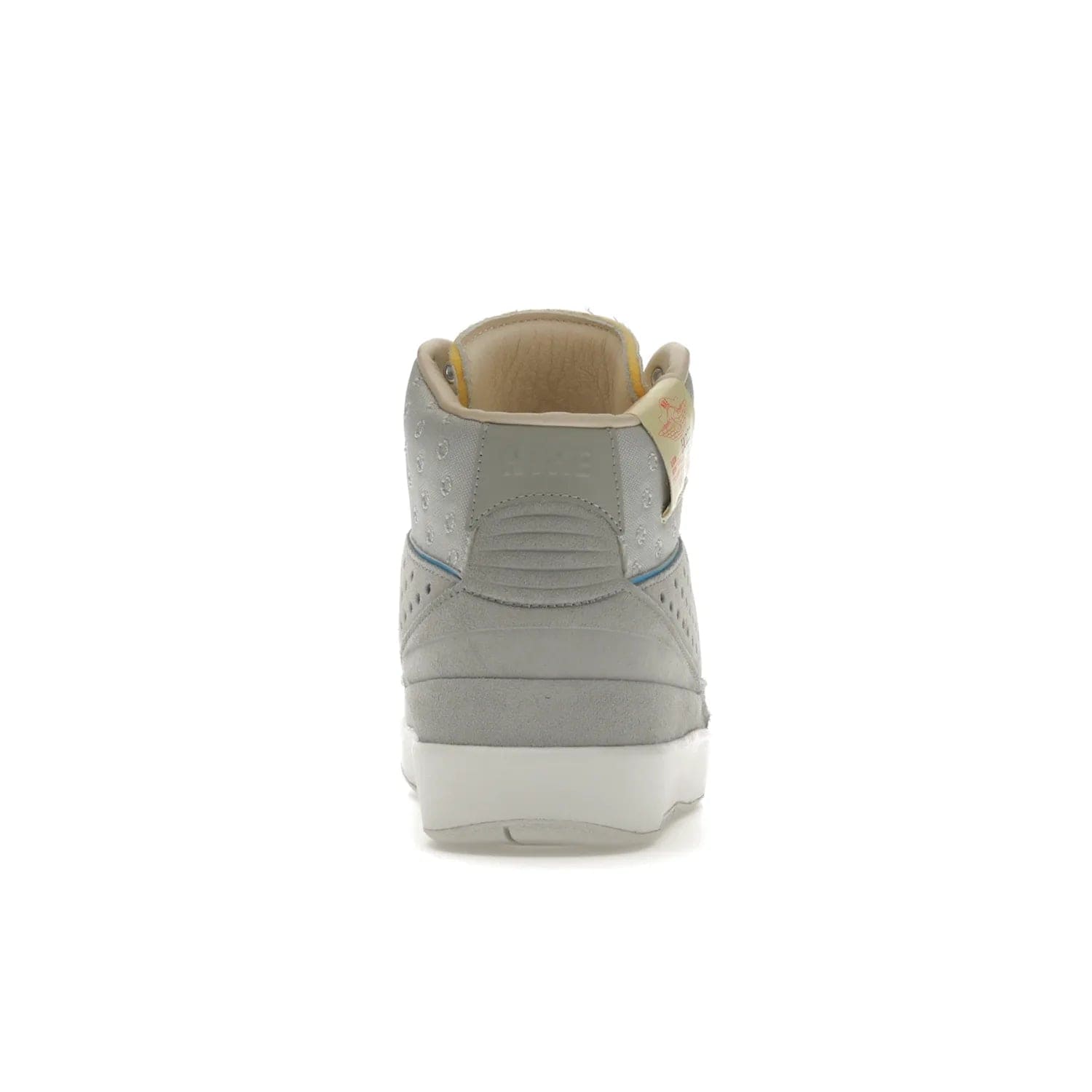 Jordan 2 Retro SP Union Grey Fog - Image 28 - Only at www.BallersClubKickz.com - Introducing the Air Jordan 2 Retro SP Union Grey Fog. This intricate sneaker design features a grey canvas upper with light blue eyelets, eyestay patches, and piping, plus custom external tags. Dropping in April 2022, this exclusive release offers a worn-in look and feel.