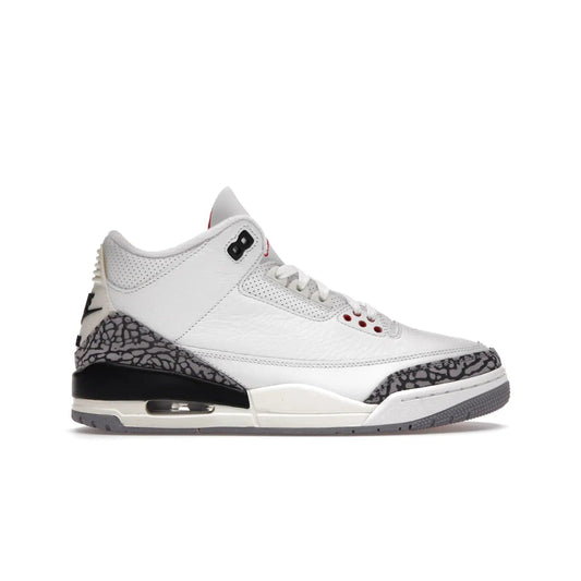 Jordan 3 Retro White Cement Reimagined - Image 1 - Only at www.BallersClubKickz.com - The Reimagined Air Jordan 3 Retro in a Summit White/Fire Red/Black/Cement Grey colorway is launching on March 11, 2023. Featuring a white leather upper, off-white midsoles and heel tabs, this vintage-look sneaker is a must-have.