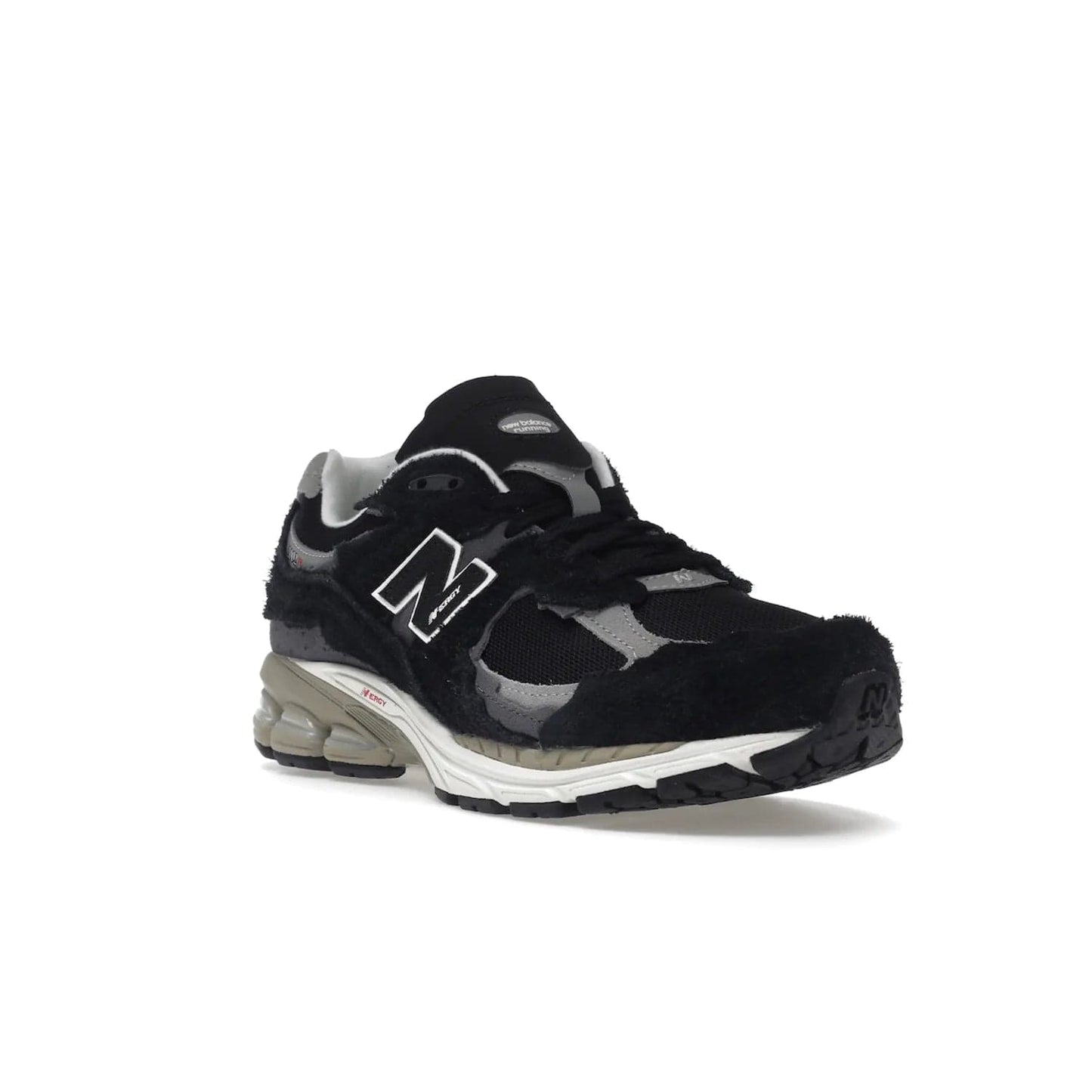 New Balance 2002R Protection Pack Black Grey - Image 6 - Only at www.BallersClubKickz.com - Look stylish in the New Balance 2002R Protection Pack Black Grey. Uppers constructed from premium materials like mesh and synthetic overlays. Iconic "N" emblem appears in white and black. ABZORB midsole for shock absorption and responsiveness. Black outsole for grip and traction. Lacing system offers customized fit and cushioned tongue and collar offer comfort and stability. Step up your style with this must-have